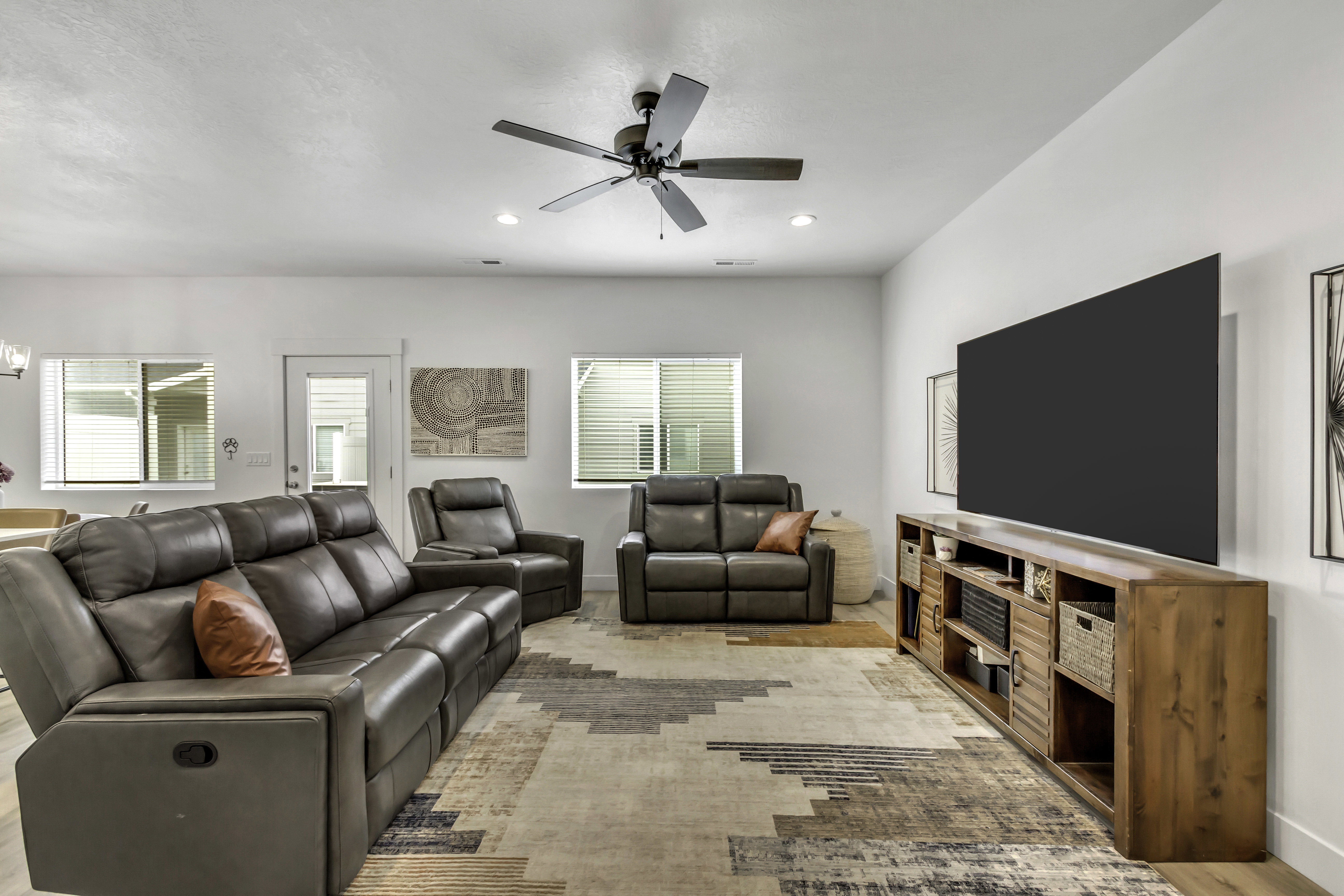 Open concept living space featuring recessed lighting, a ceiling fan, multiple windows with blinds, a white door, and light wood-finish flooring