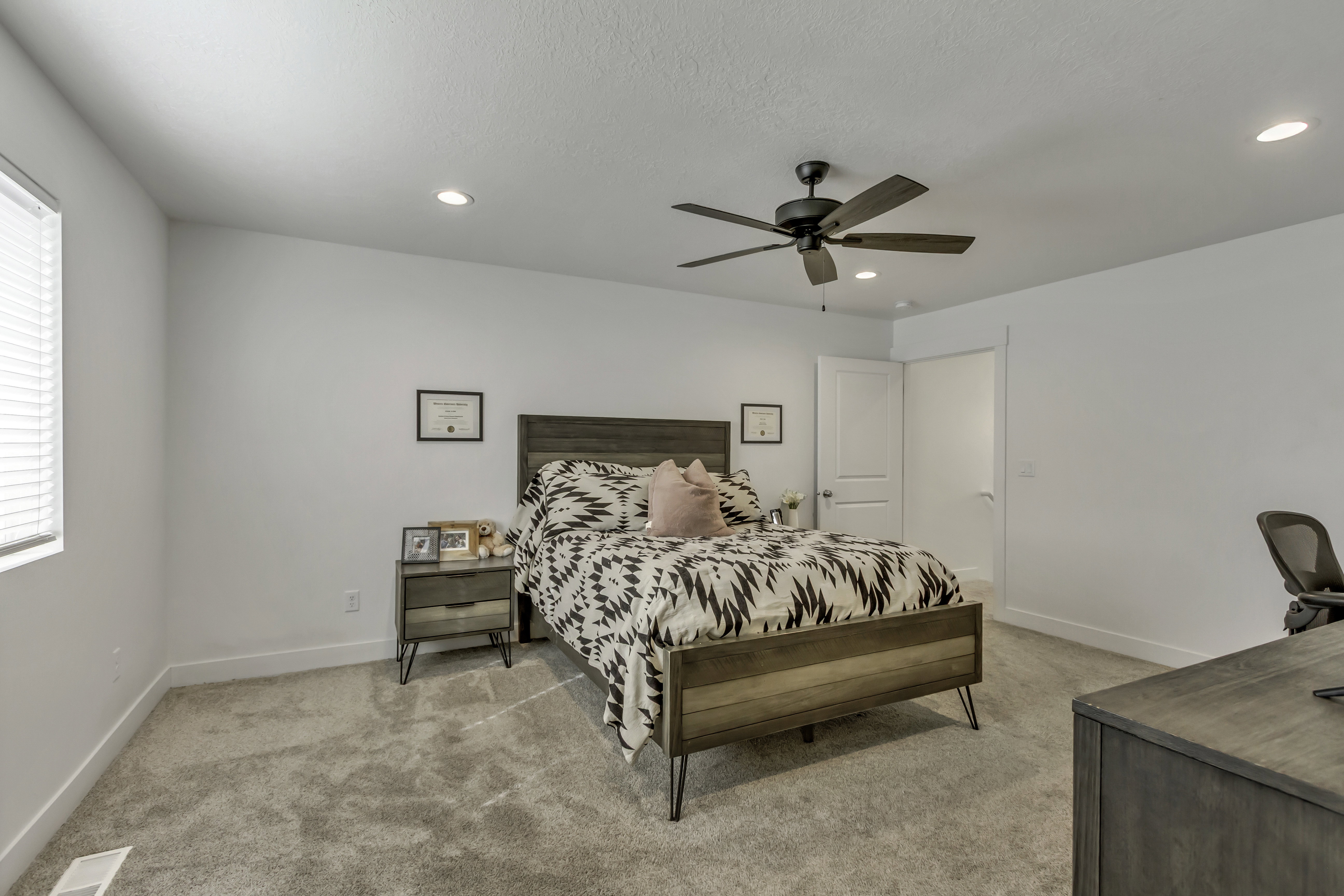 Spacious room featuring neutral carpeting, recessed lighting, and a ceiling fan