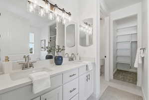 Double vanity featuring undermount sinks, brushed nickel fixtures, and light-toned countertops