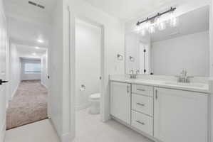 Double vanity with white cabinetry and integrated sinks