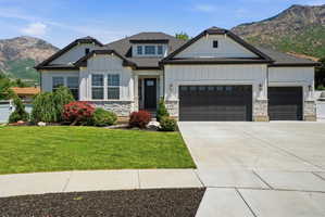 Modern farmhouse exterior with crisp white siding, dark trim, a two-car and a single-car garage, and a concrete driveway