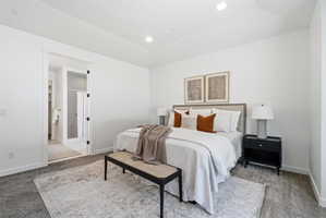 Spacious bedroom featuring recessed lighting and plush carpet flooring