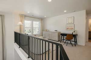 Upper-level landing featuring a black metal railing