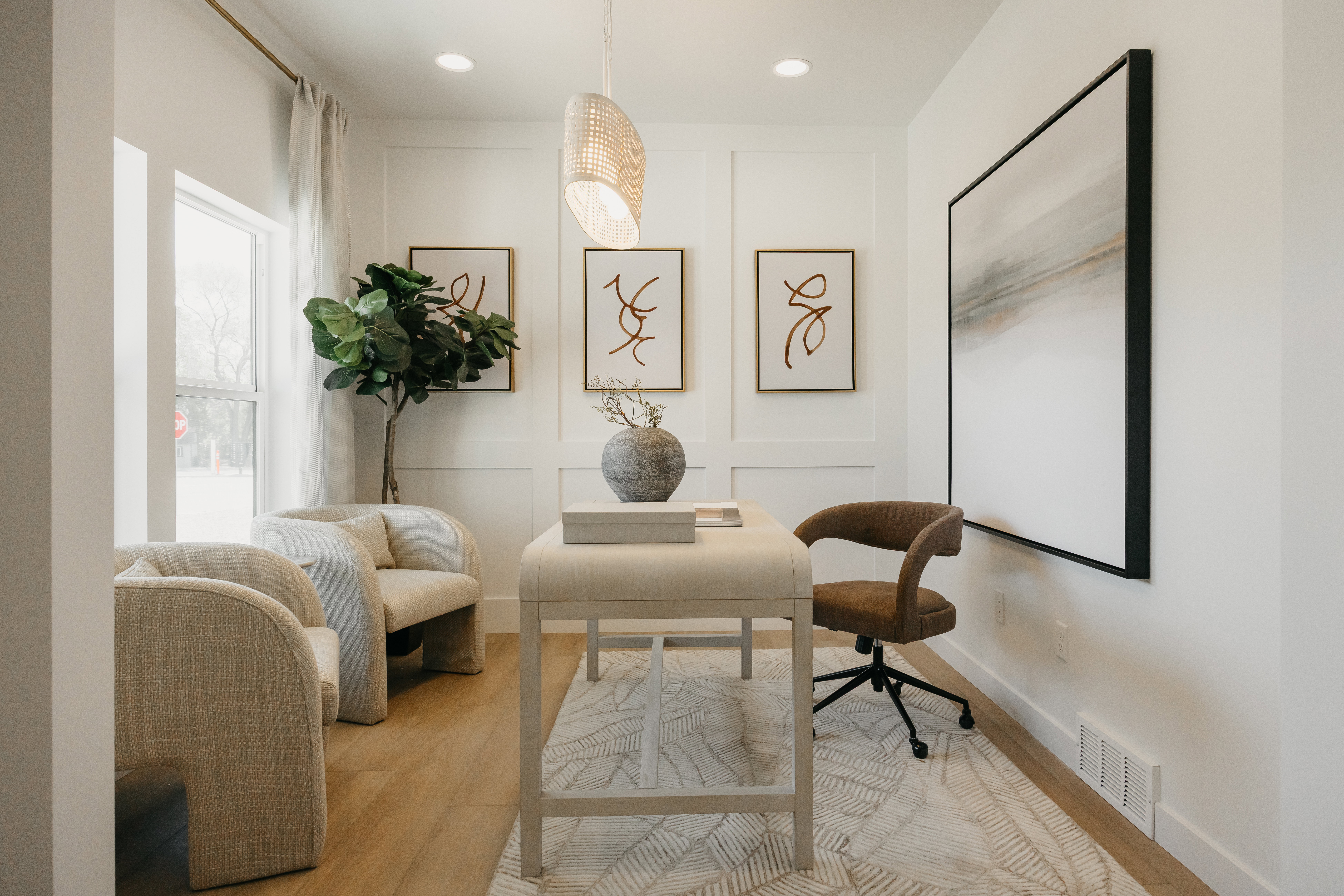 Bright room featuring light wood-finish flooring, recessed lighting, and a window with sheer drapes