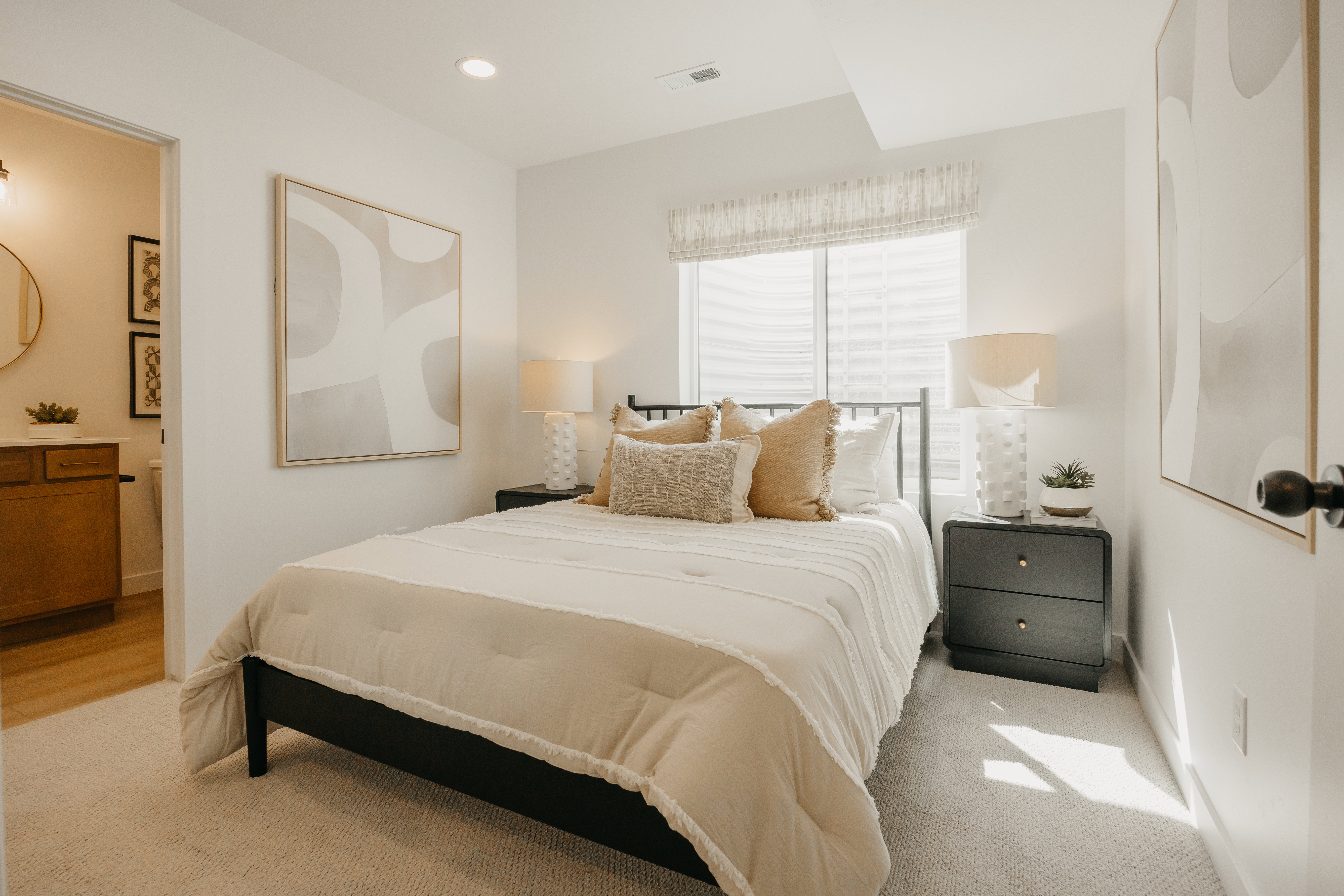 Bedroom featuring light-toned carpeting, recessed lighting, and a large window with privacy shades