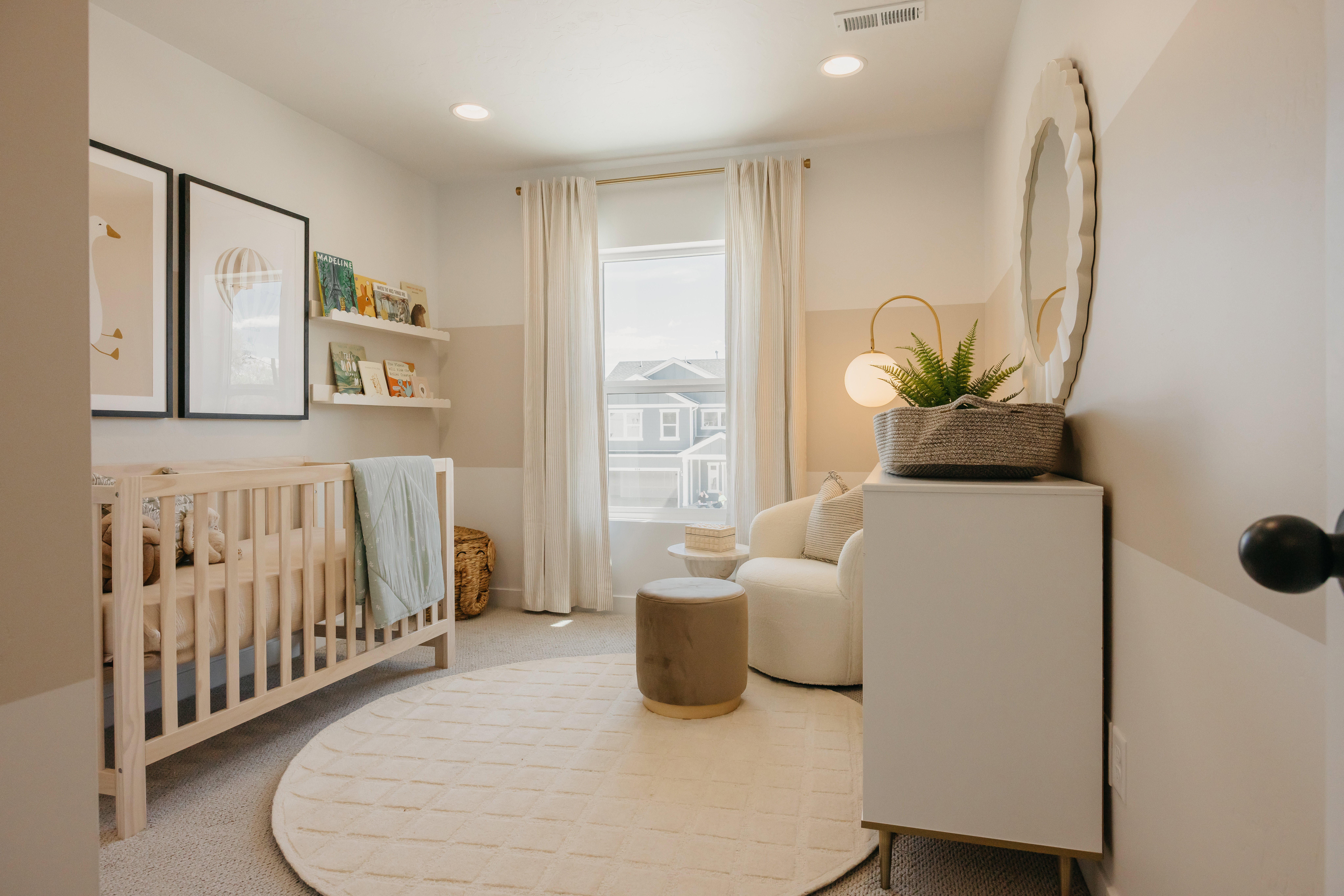 Bright room featuring carpet flooring and a window with white drapes