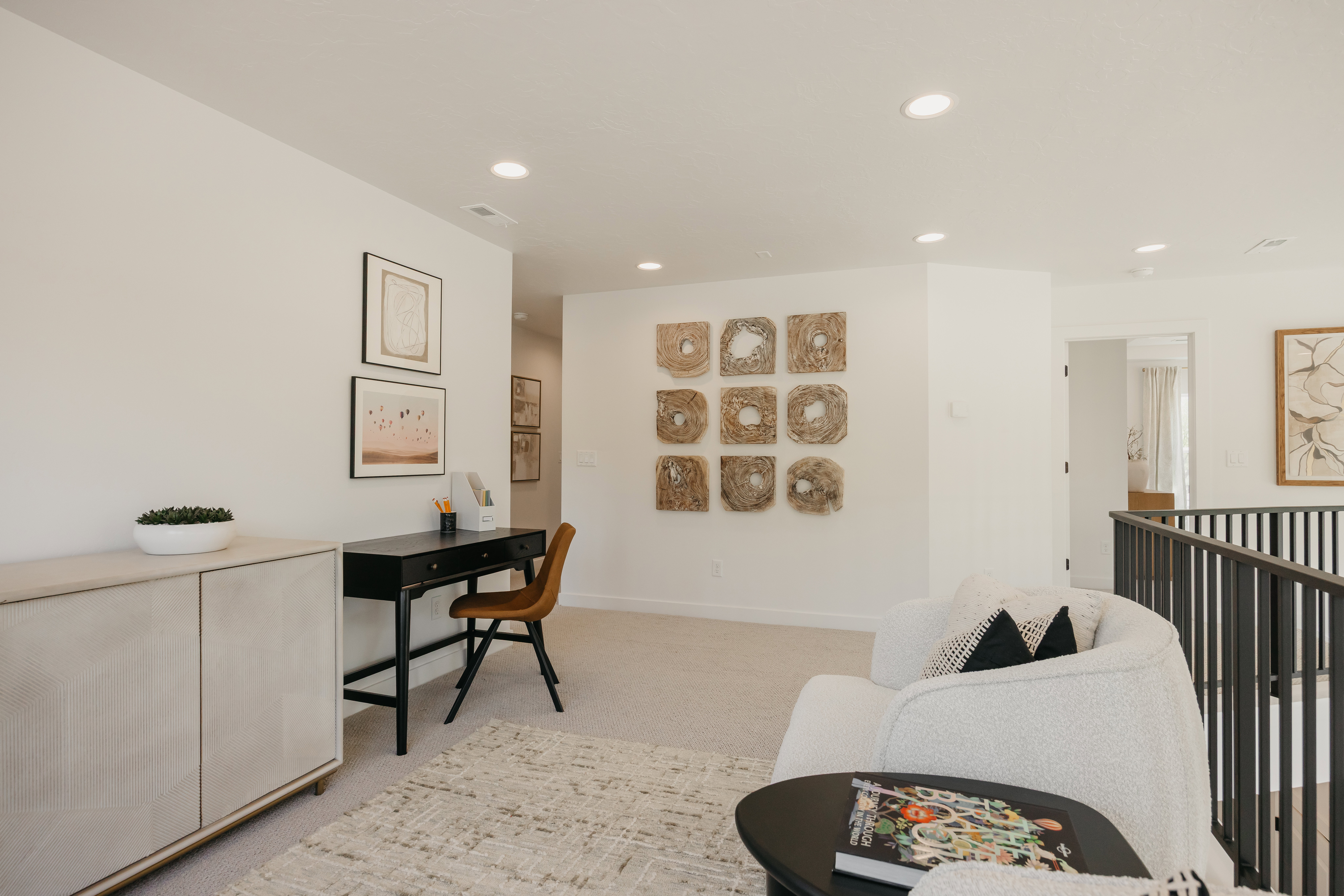 Loft area featuring recessed lighting, light-colored carpeting, and a dark metal railing