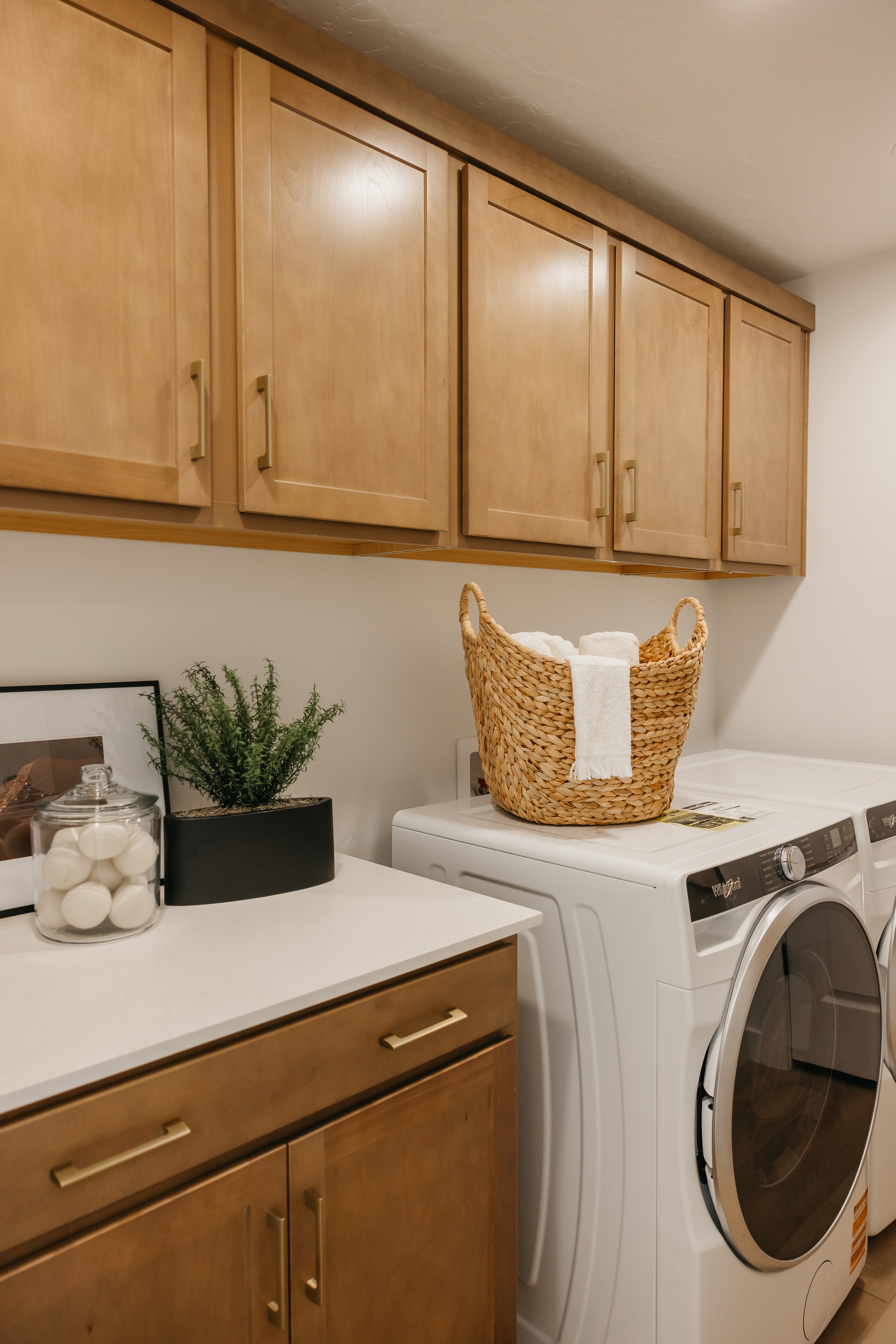 Light wood-finish cabinetry featuring brushed gold hardware