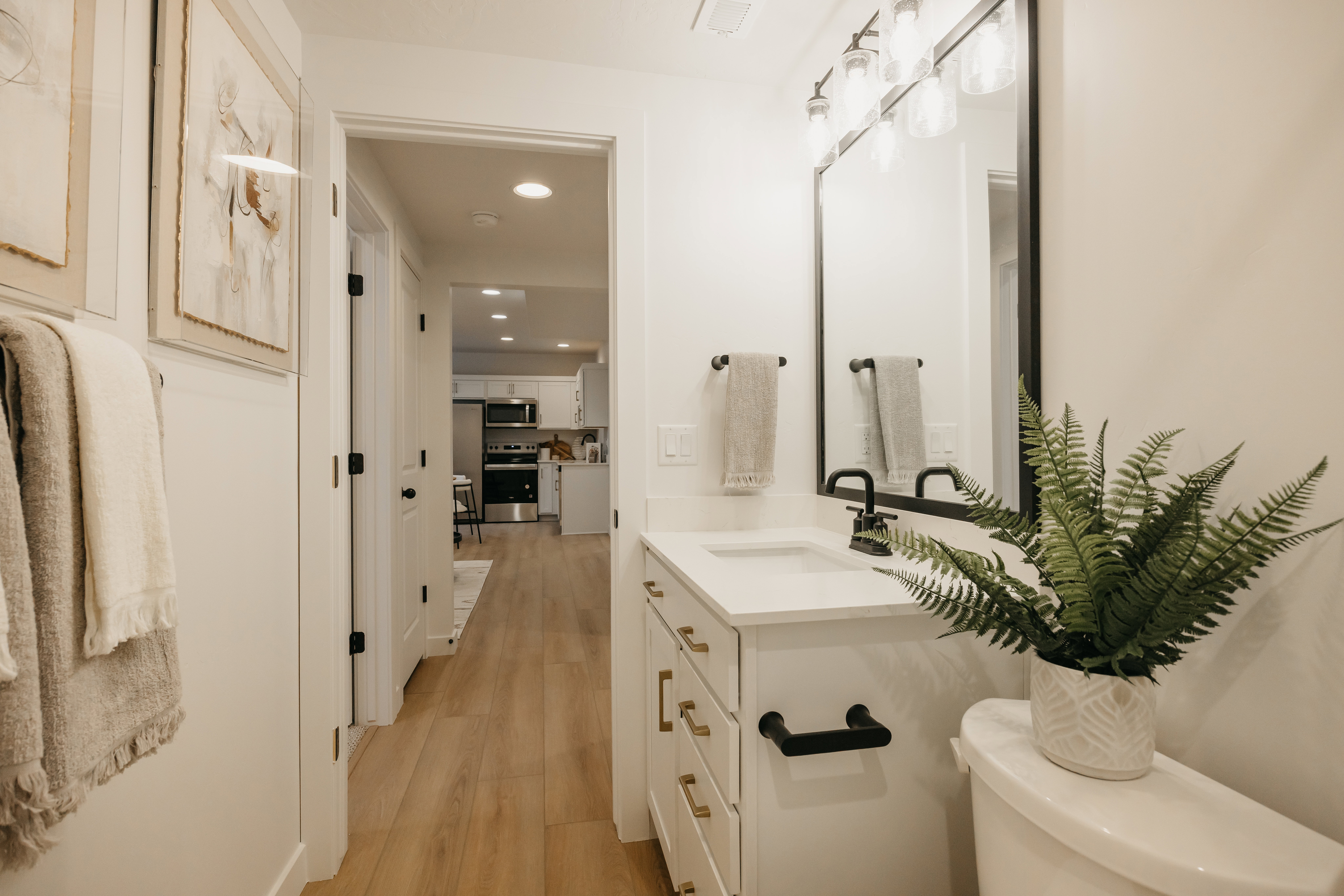 Bathroom vanity featuring a white countertop, undermount sink, and matte black faucet