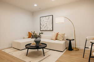 Recessed ceiling lighting illuminates the light-toned walls and wood-finish flooring
