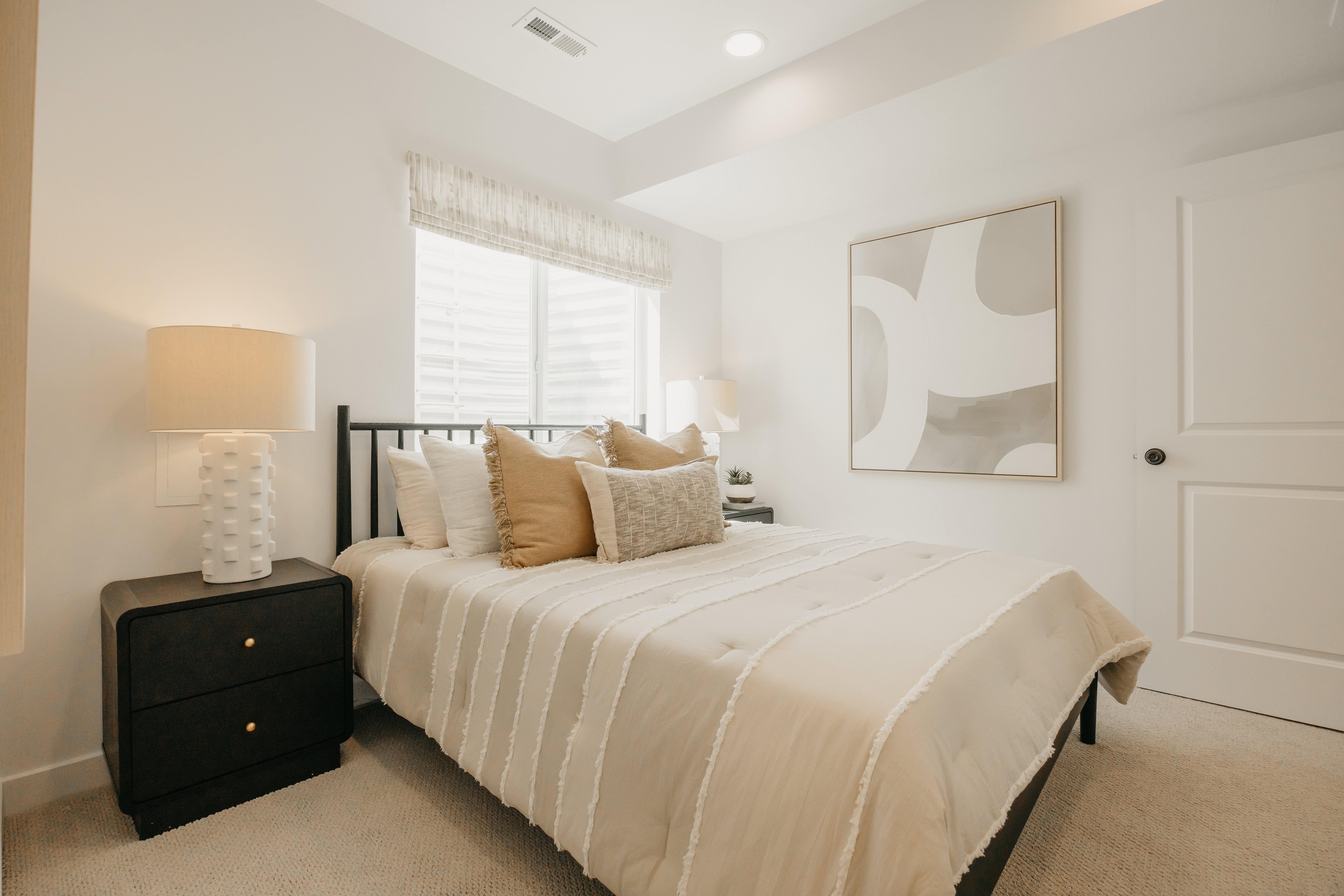 Bright room featuring light-colored wall paint and carpet