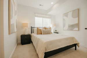 Carpeted room featuring a window with a Roman shade, recessed lighting, and white baseboards