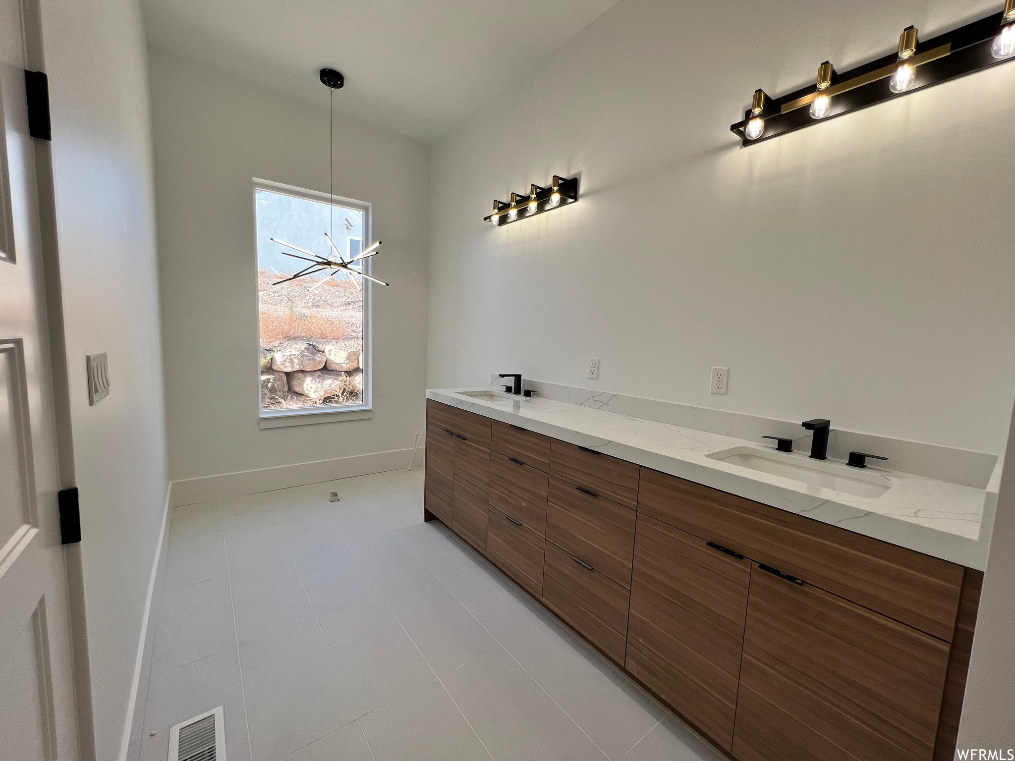 Contemporary bathroom vanity featuring a dual sink design with matte black faucets