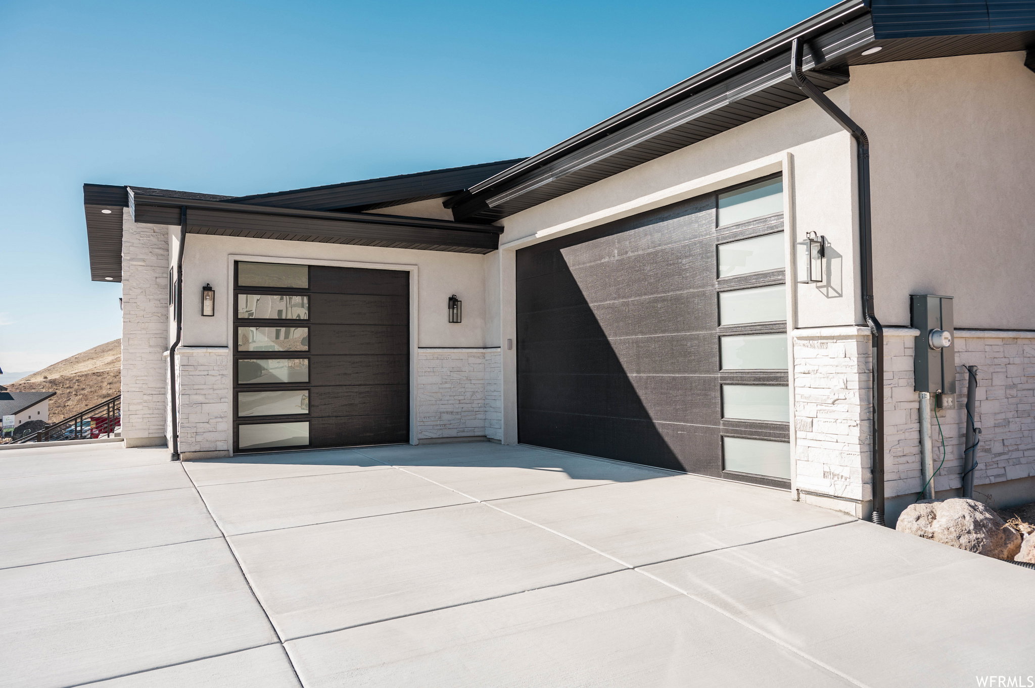 Modern garage doors featuring frosted glass panels and sleek black finishes
