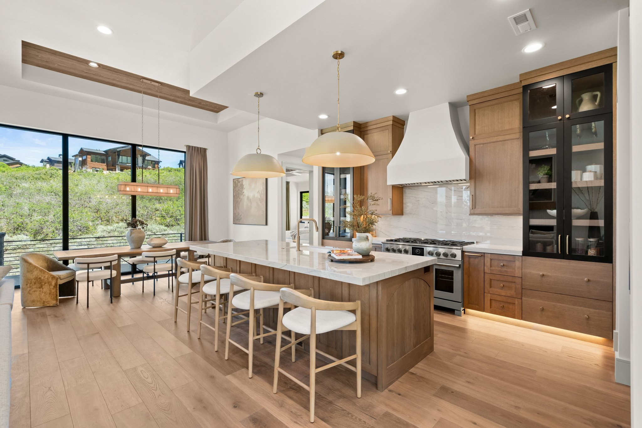 Open-concept kitchen and dining area featuring wide plank wood-finish flooring