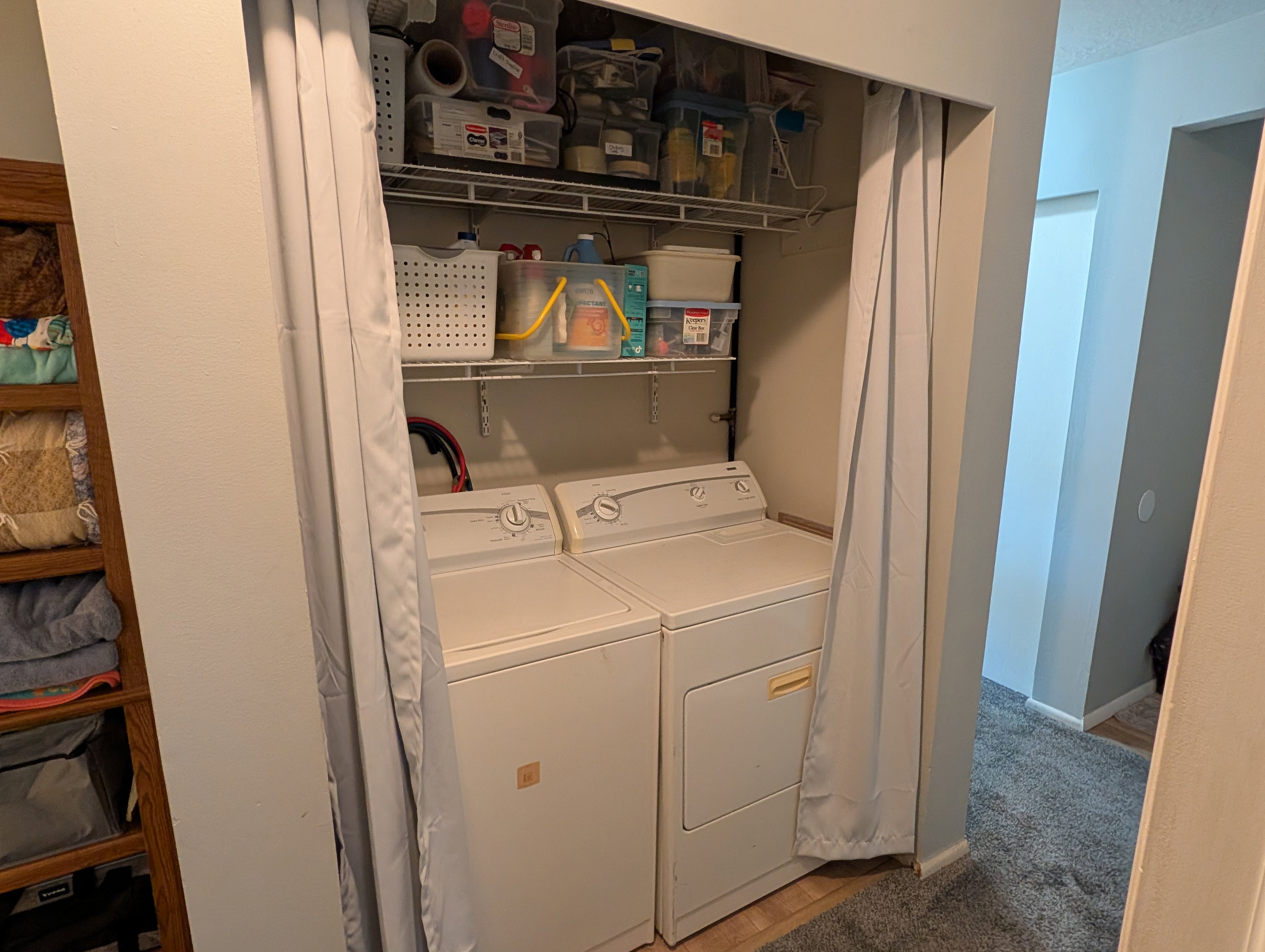 Laundry area featuring built-in wire shelving and dedicated appliance space