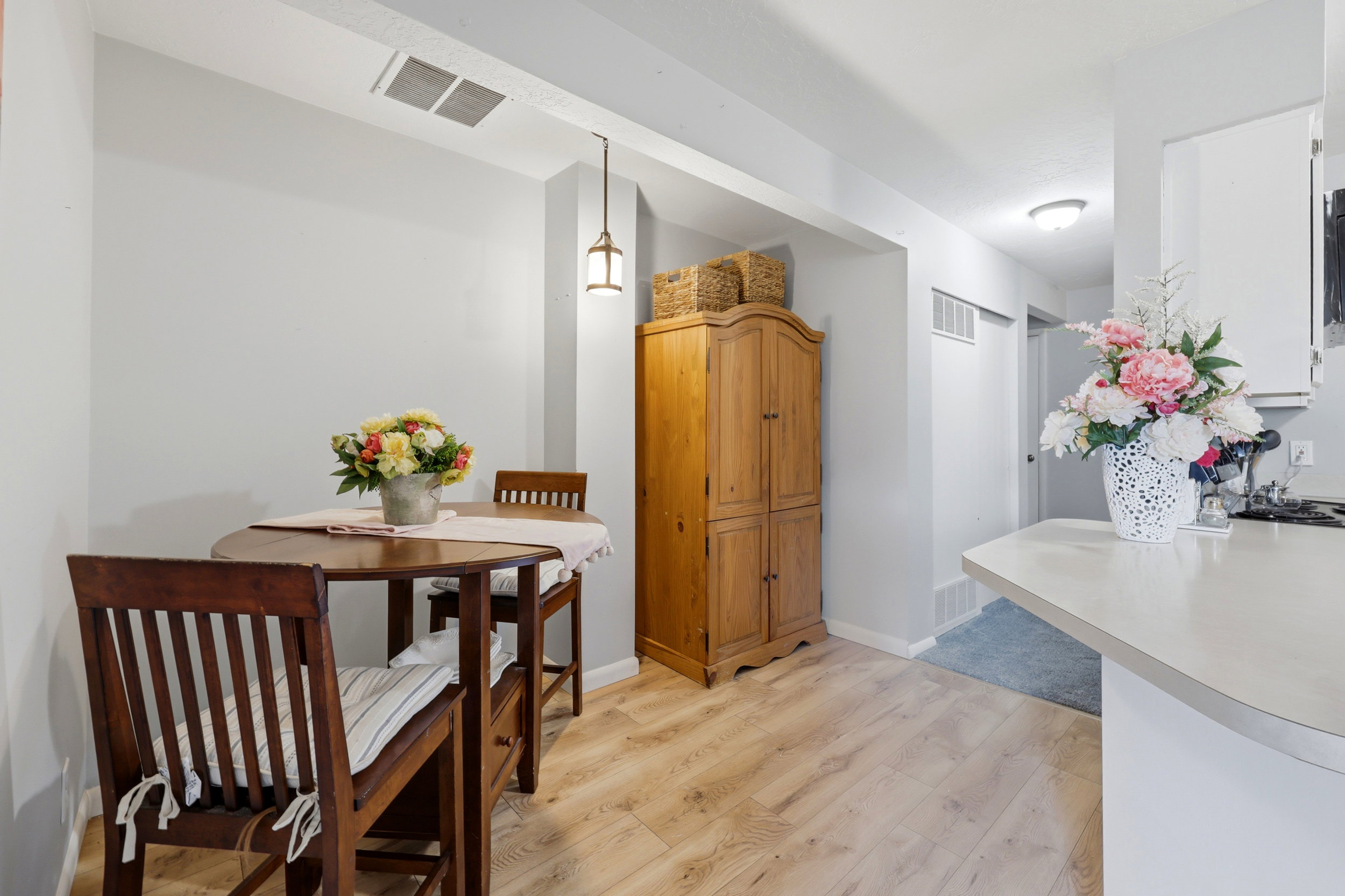 Dining area featuring wood-finish flooring and a built-in pendant light fixture