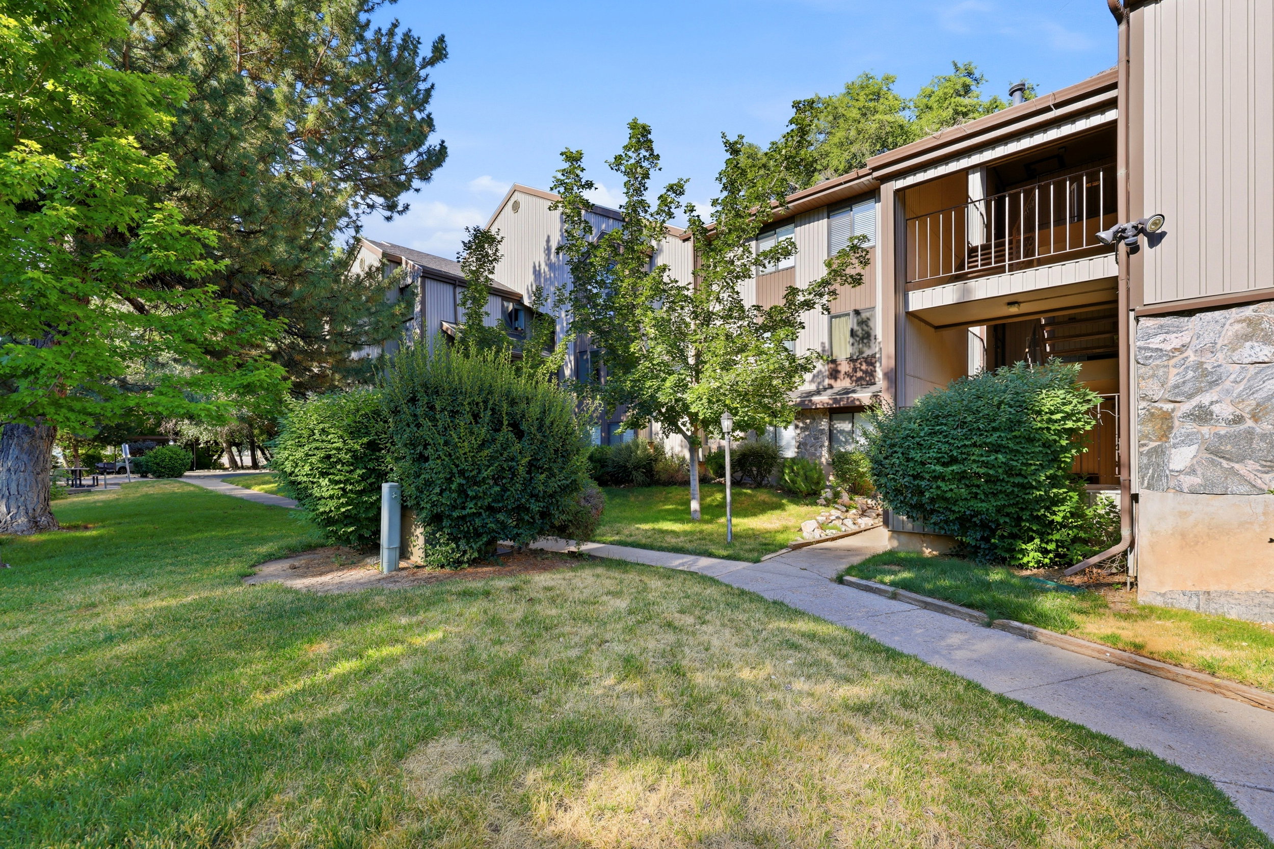 Landscaped grounds featuring mature trees and shrubbery