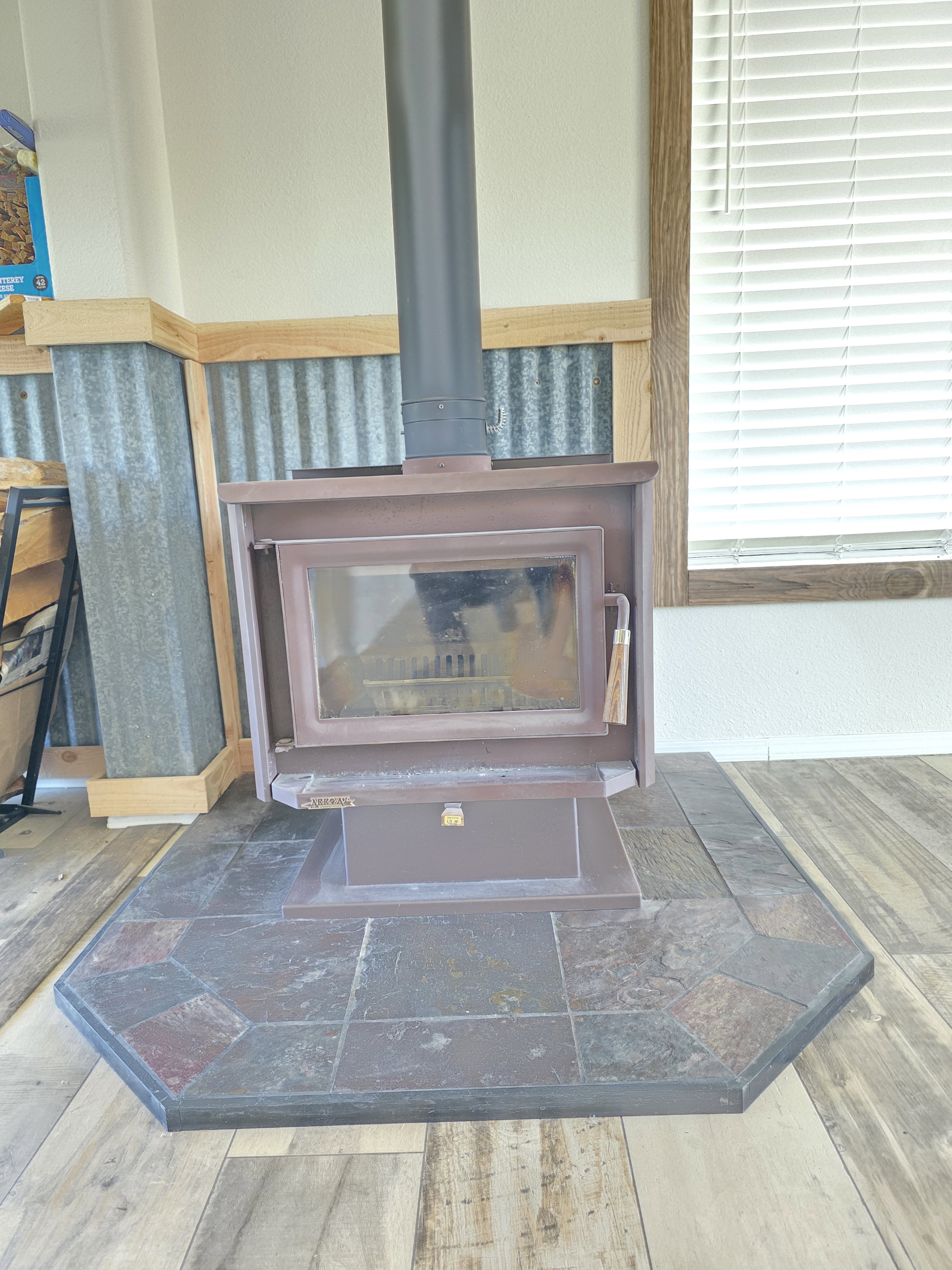 Freestanding wood-burning stove with a slate tile hearth
