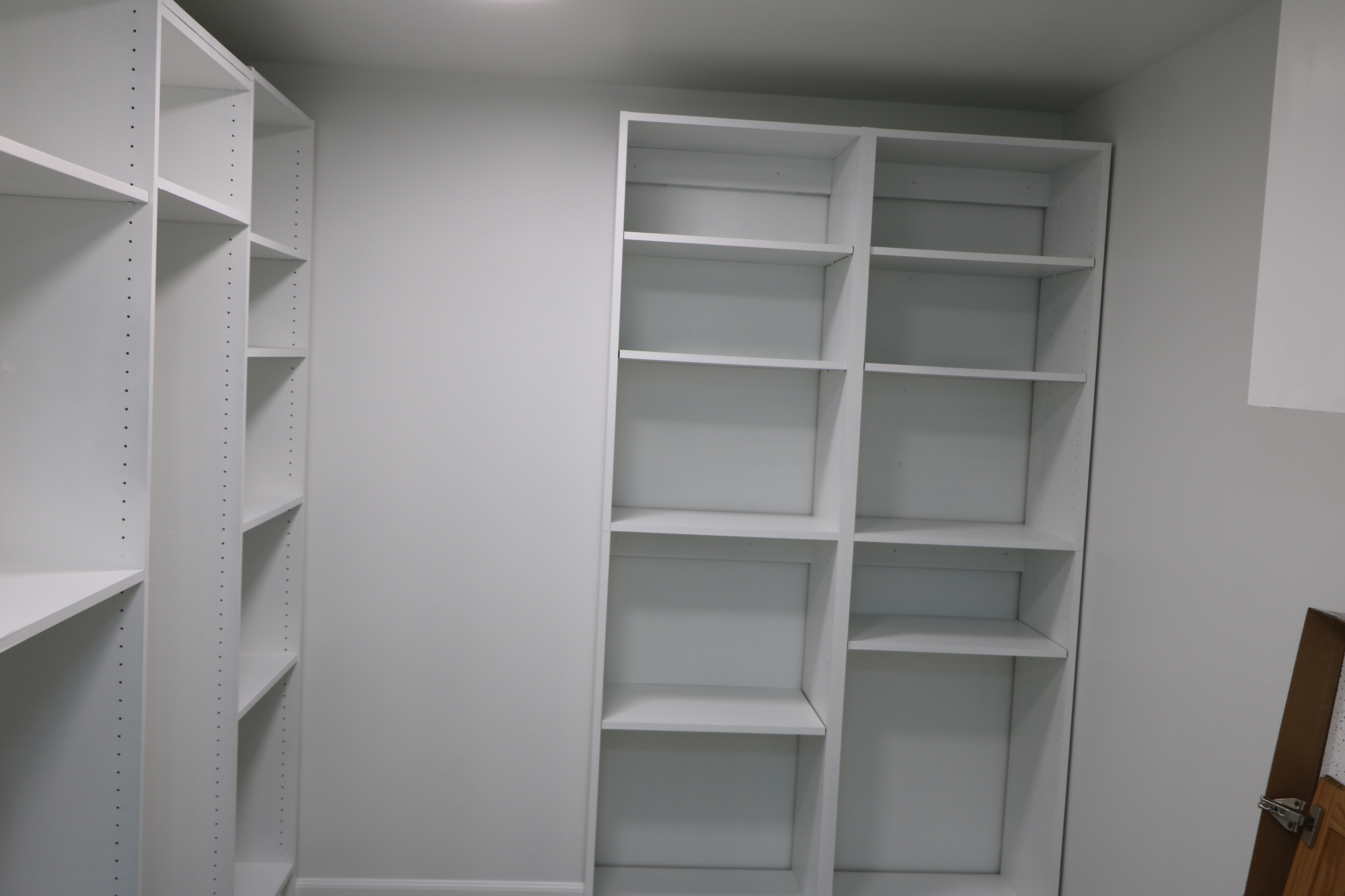 Built-in shelving units featuring adjustable white shelves, providing versatile storage solutions