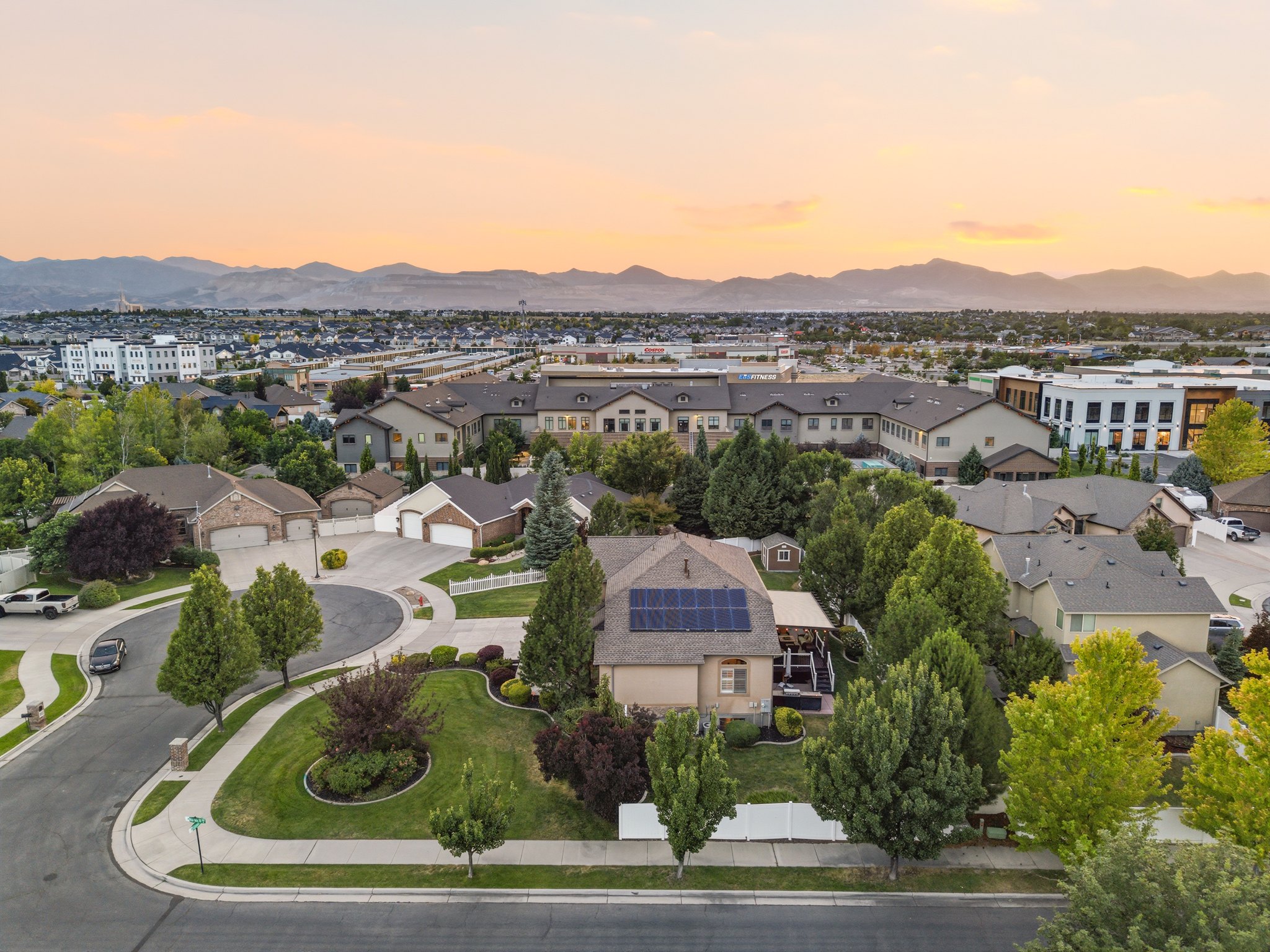Aerial perspective showcasing a residential neighborhood with distant mountains