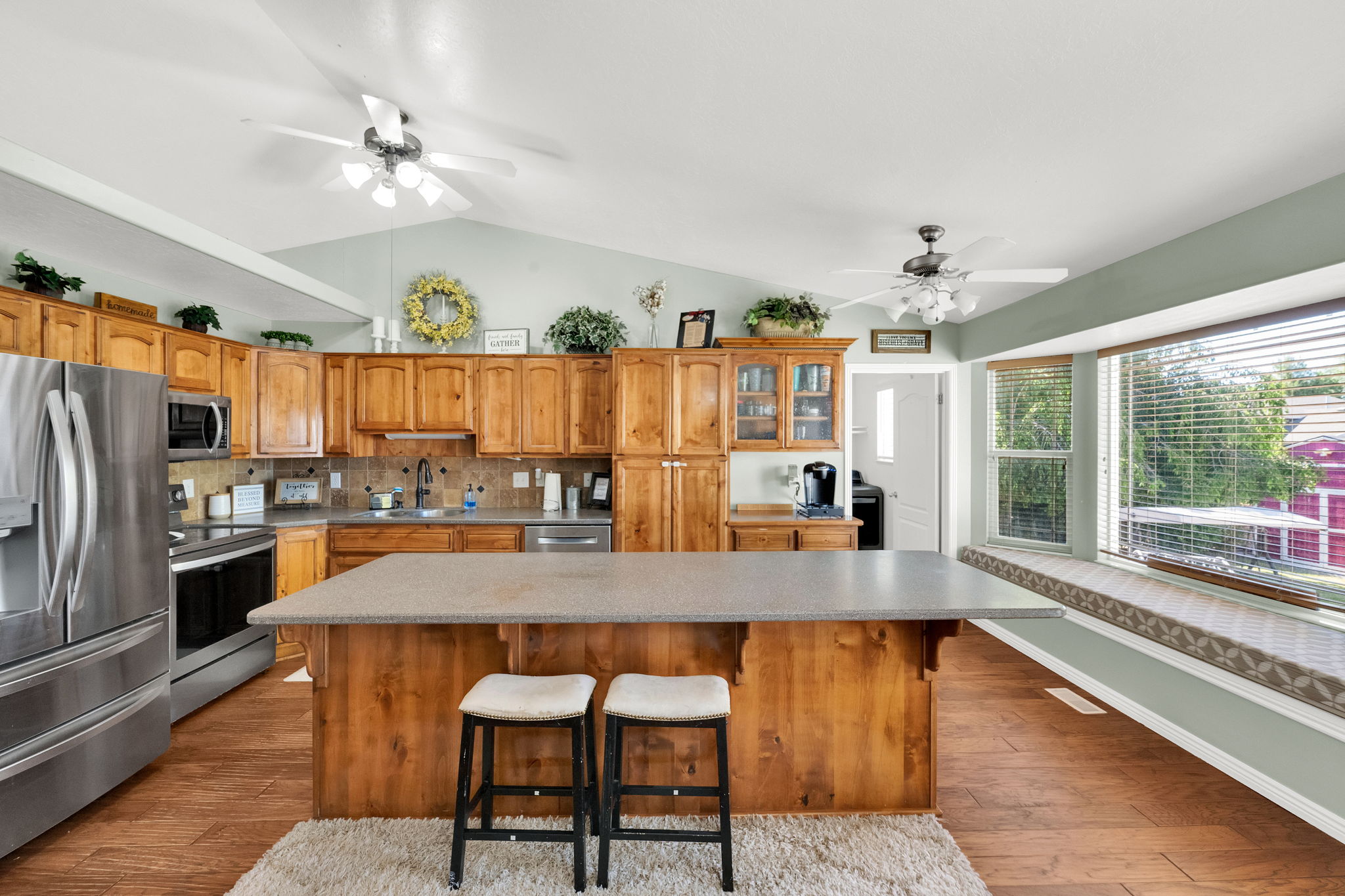 Kitchen featuring a central island, wood-finish flooring, and natural wood cabinetry