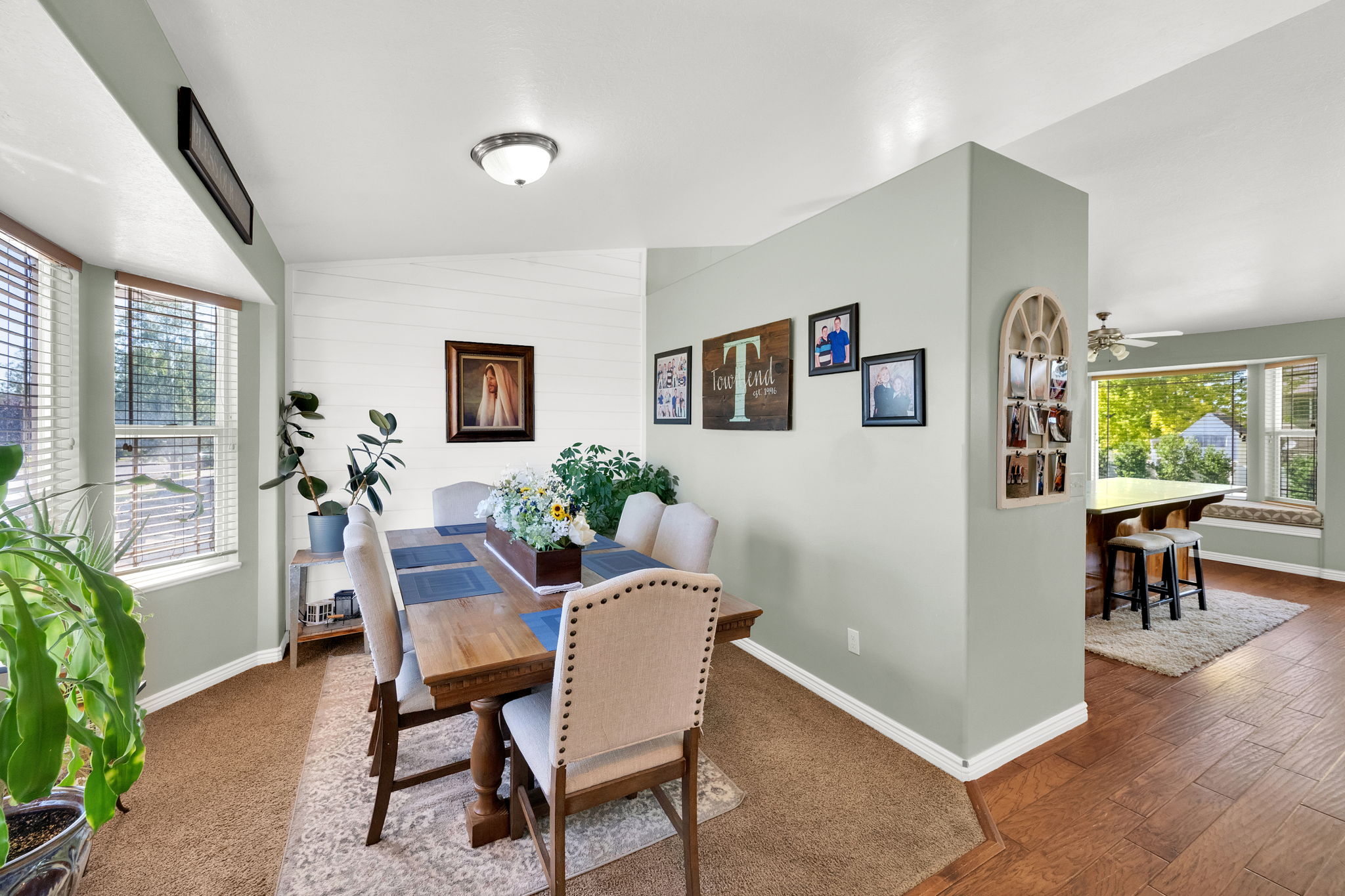 Dining area with bay windows and natural wood-finish flooring