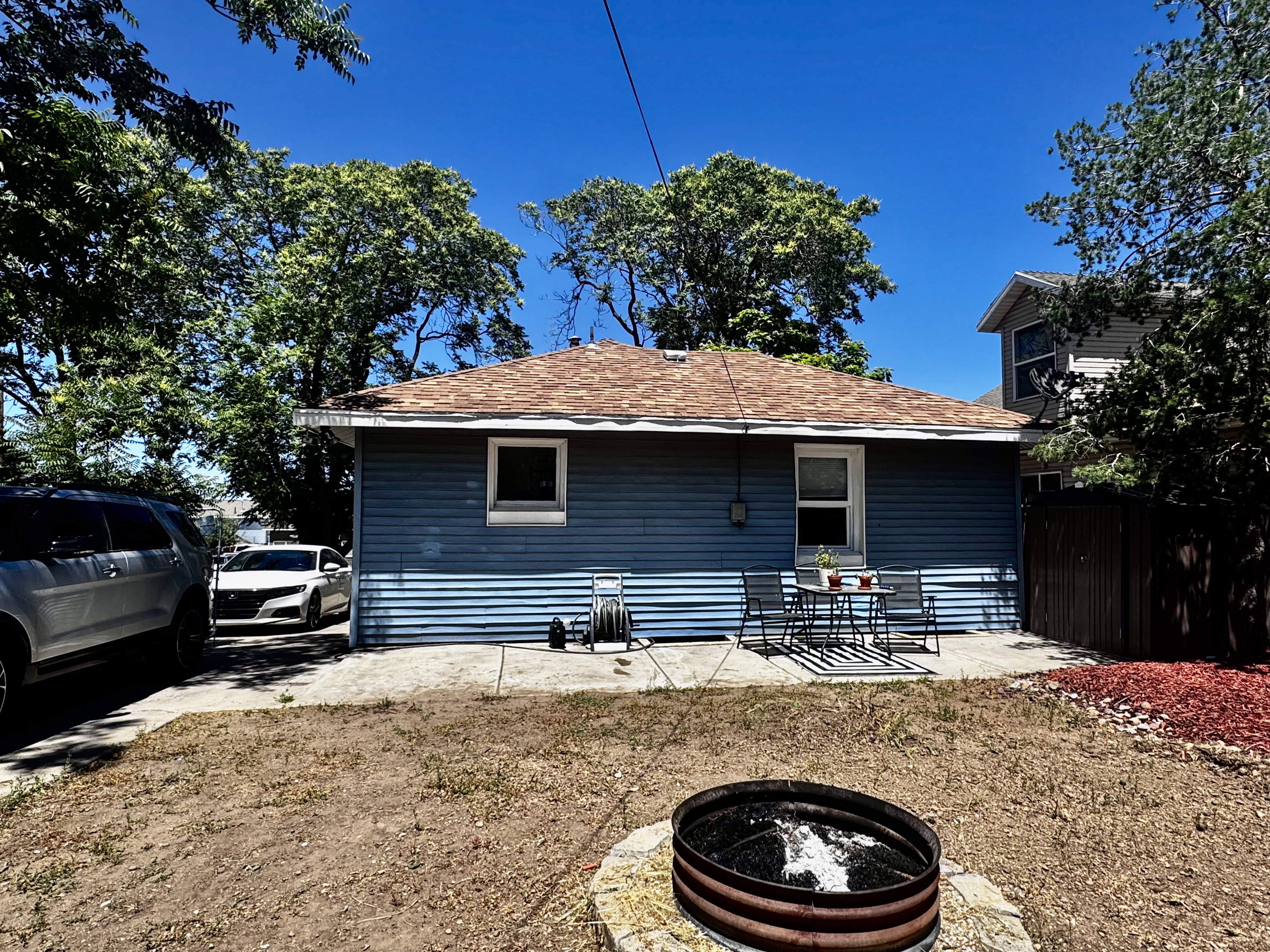 Blue siding exterior with a brown shingle roof