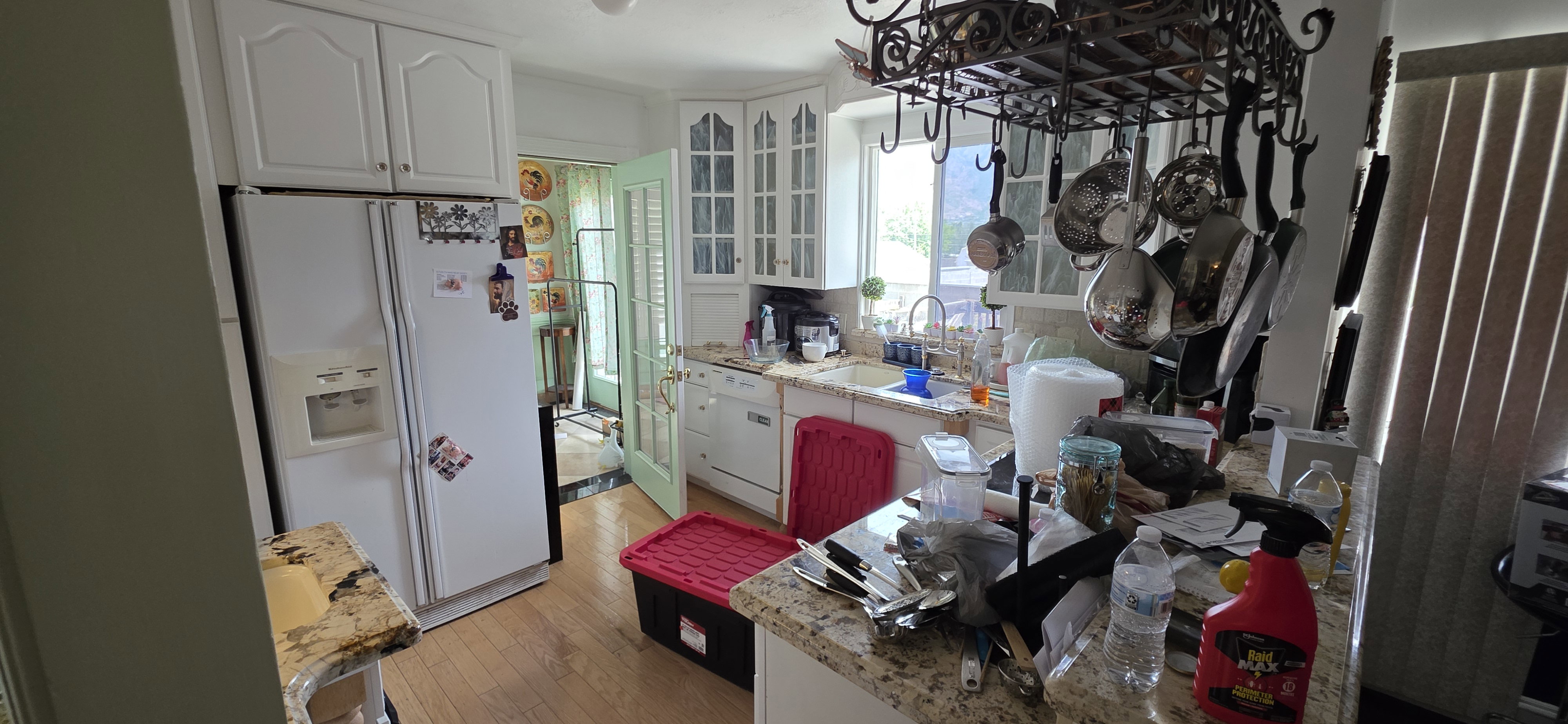 Kitchen featuring wood-finish flooring, white cabinetry, granite countertops, and a double-door refrigerator