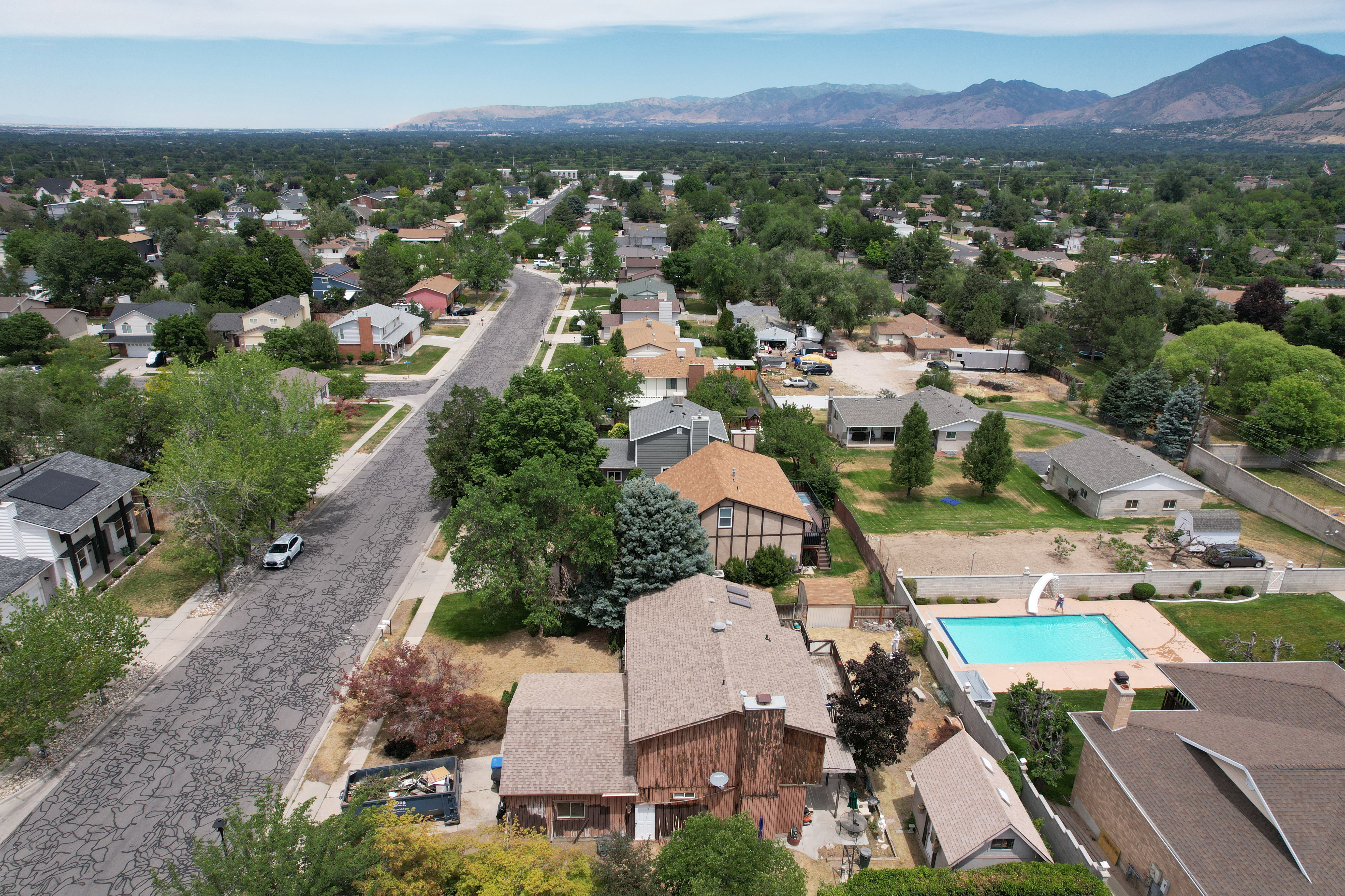Aerial perspective showcasing residential properties and a mountain backdrop
