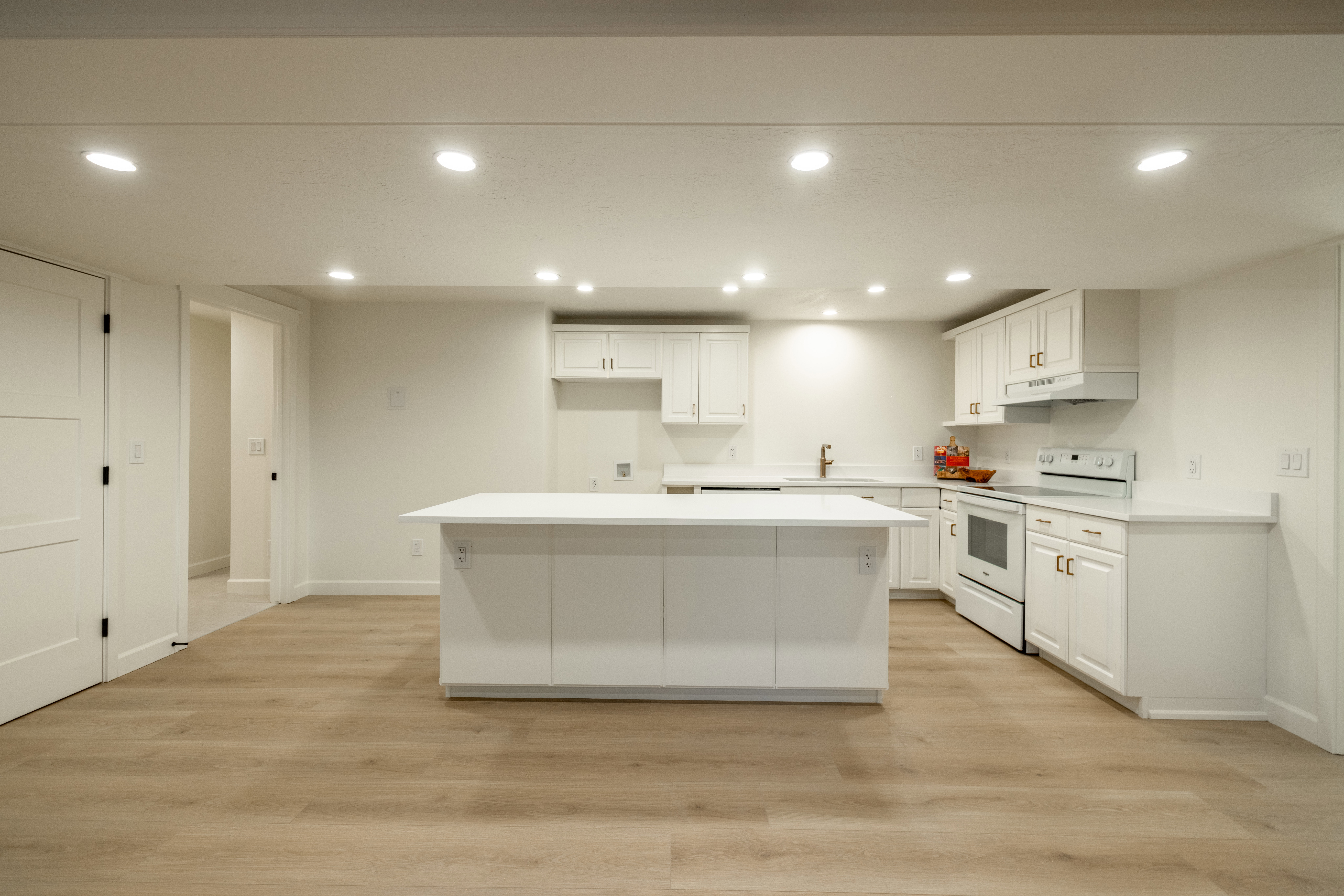Kitchen for ADU featuring large island and quartz countertops
