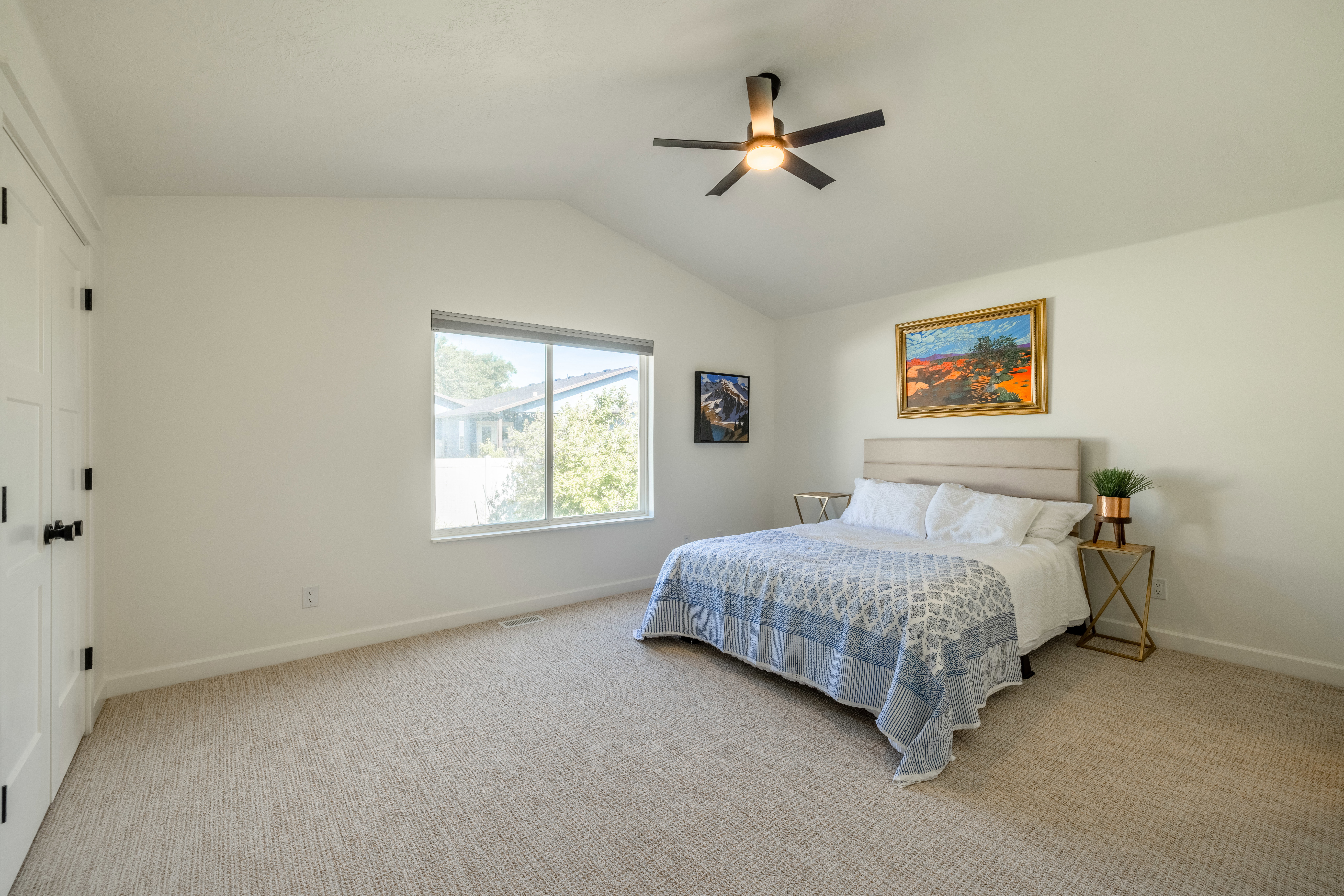 Primary bedroom with vaulted ceilings