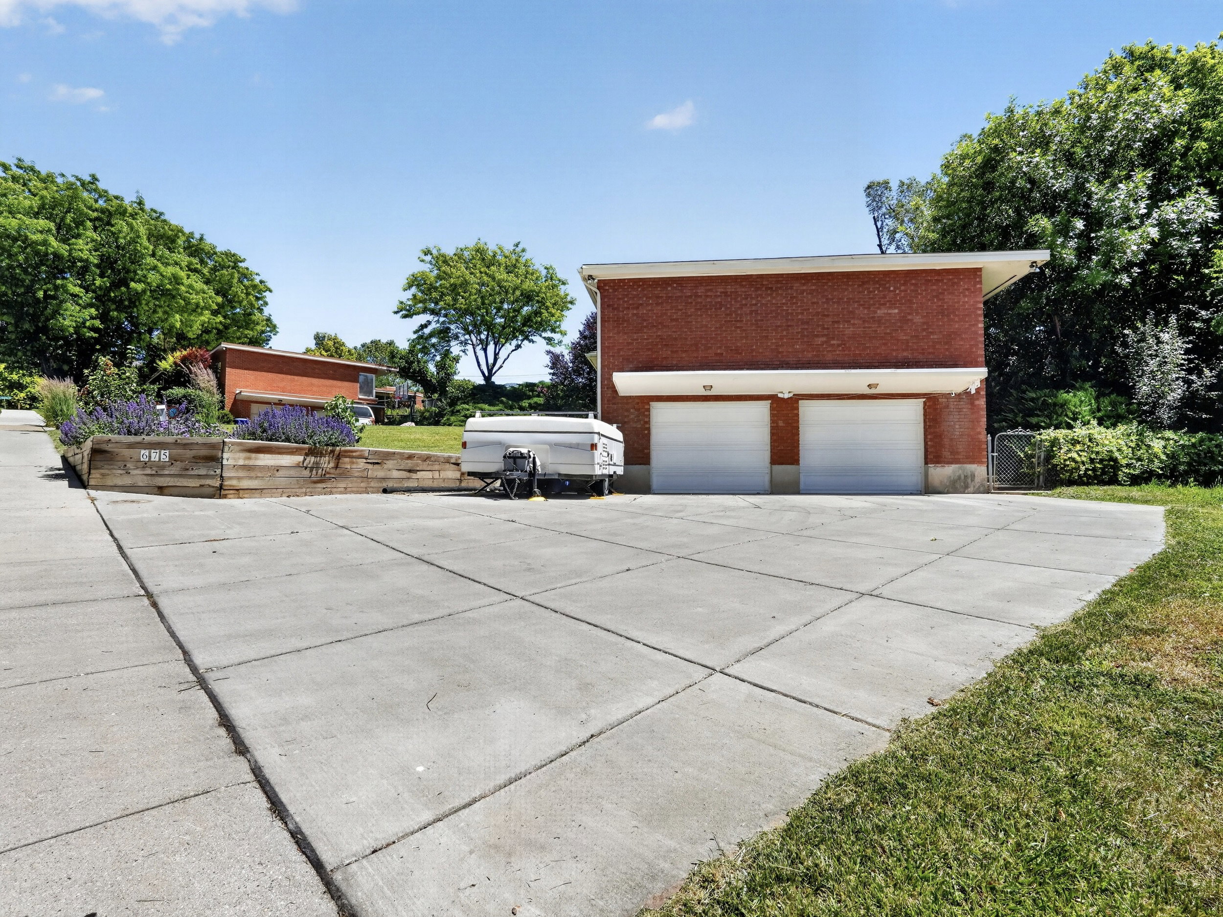 Driveway with RV/camper parking and 2 garage doors