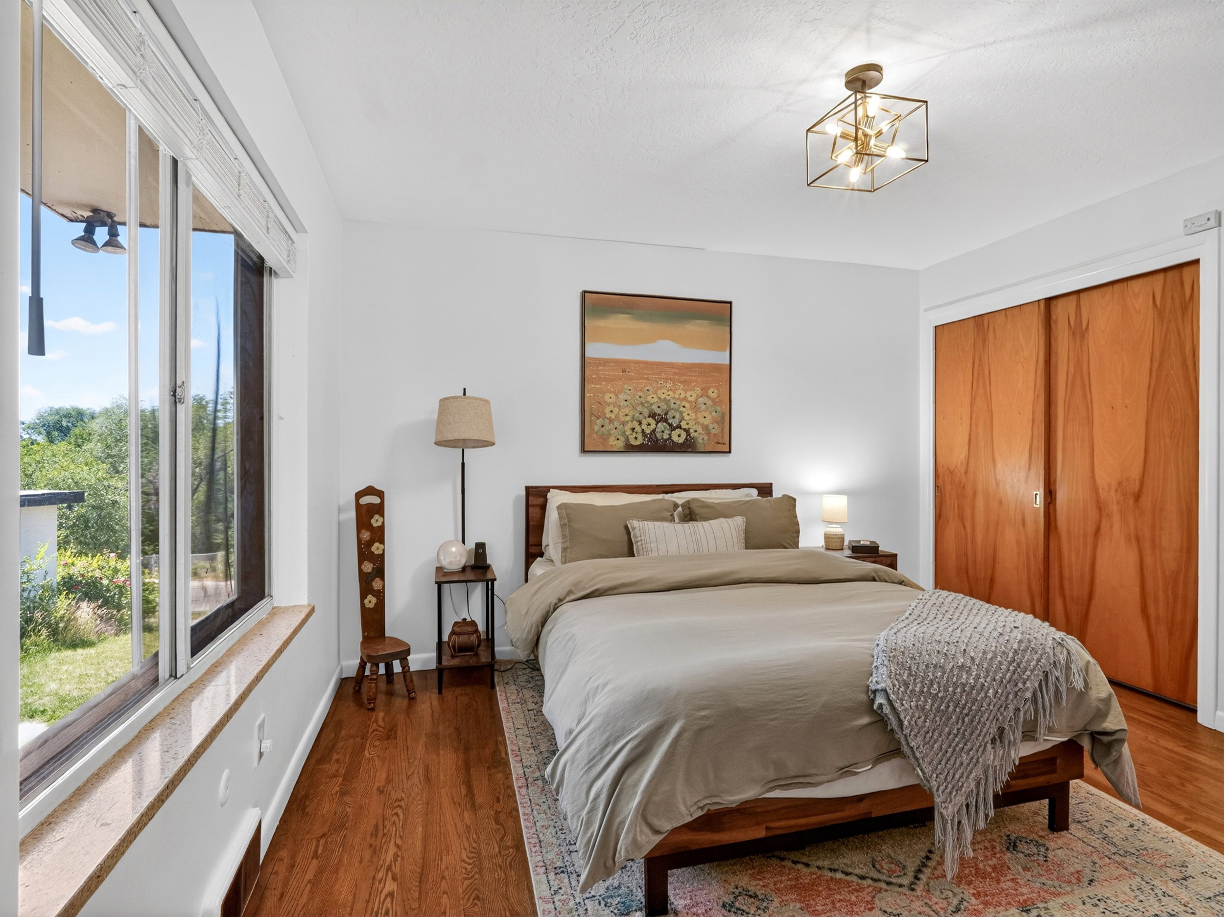 Primary bedroom with large window and a spacious closet.