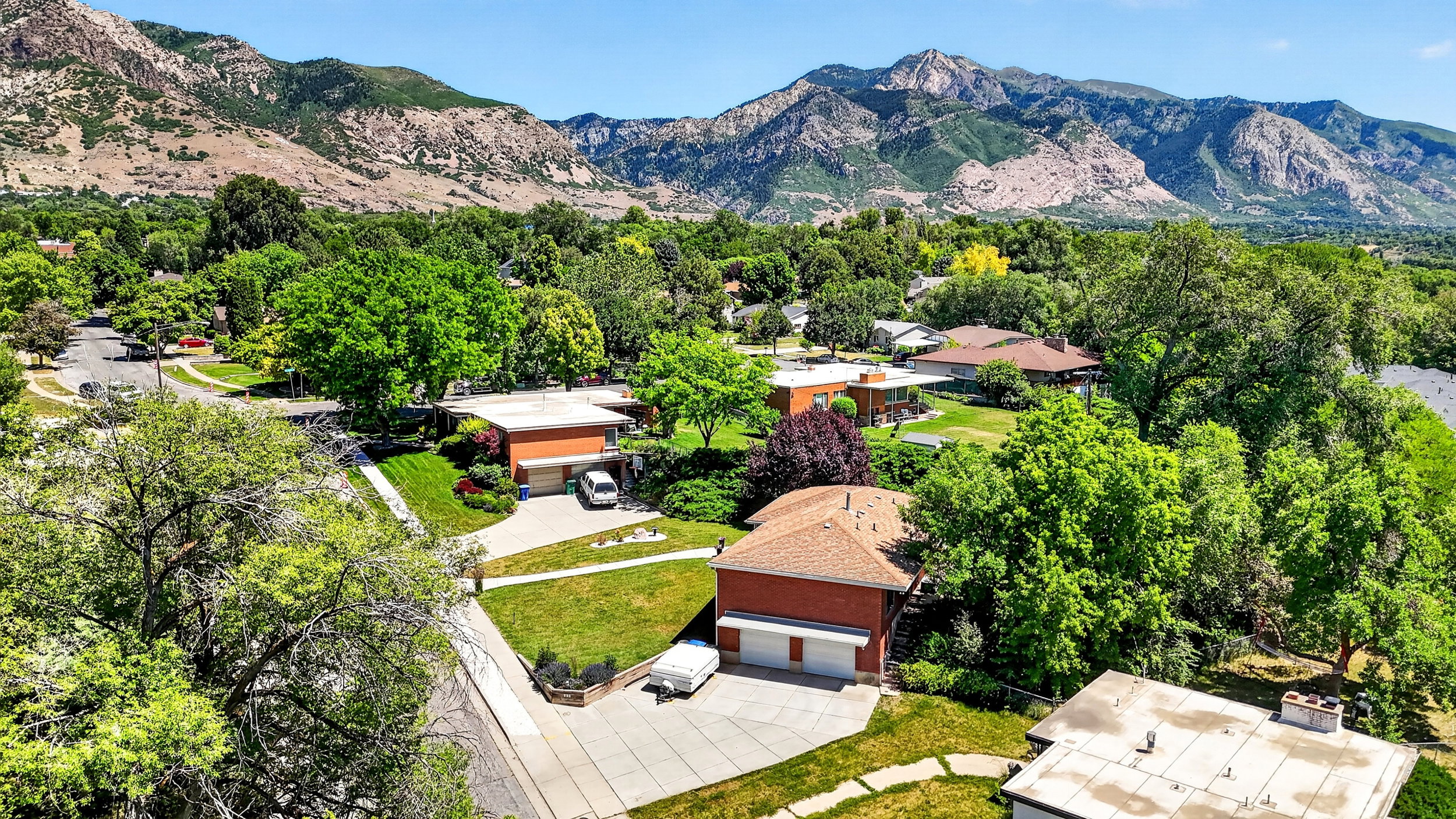 Aerial view showing quiet street and proximity to mountain.