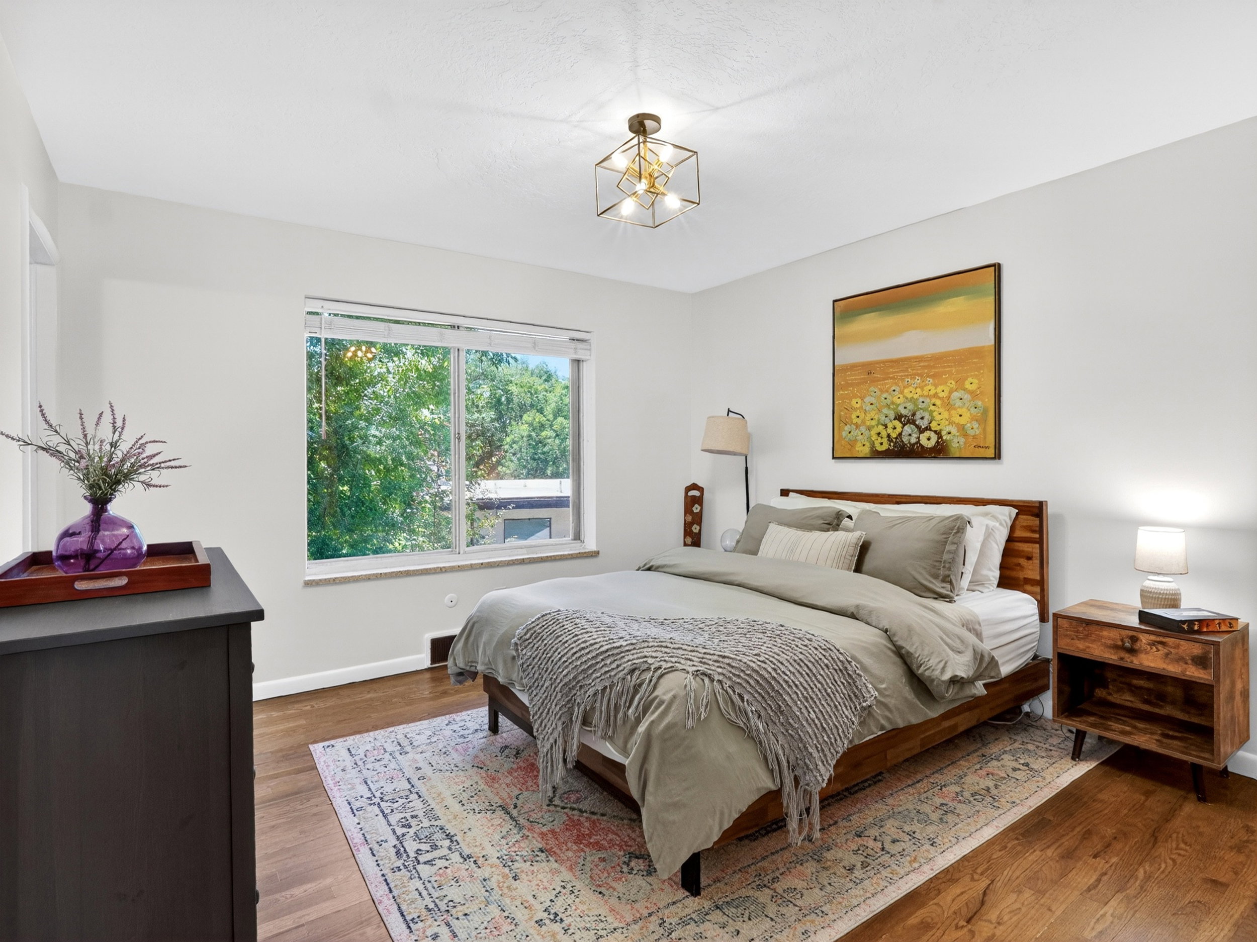 Primary bedroom with large window and a spacious closet.