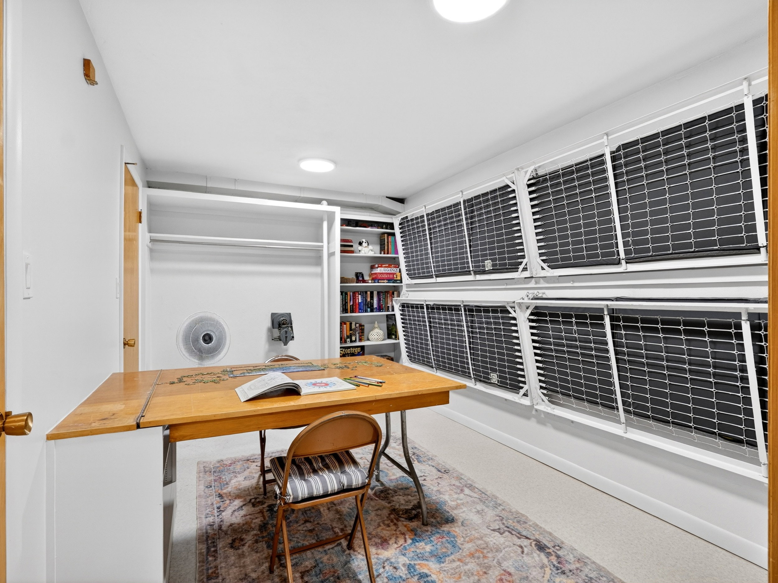 Multi-function room fwith built-in shelving.  The room is equipped with bunk beds and a craft table that can be folded up to make the room fit your needs.