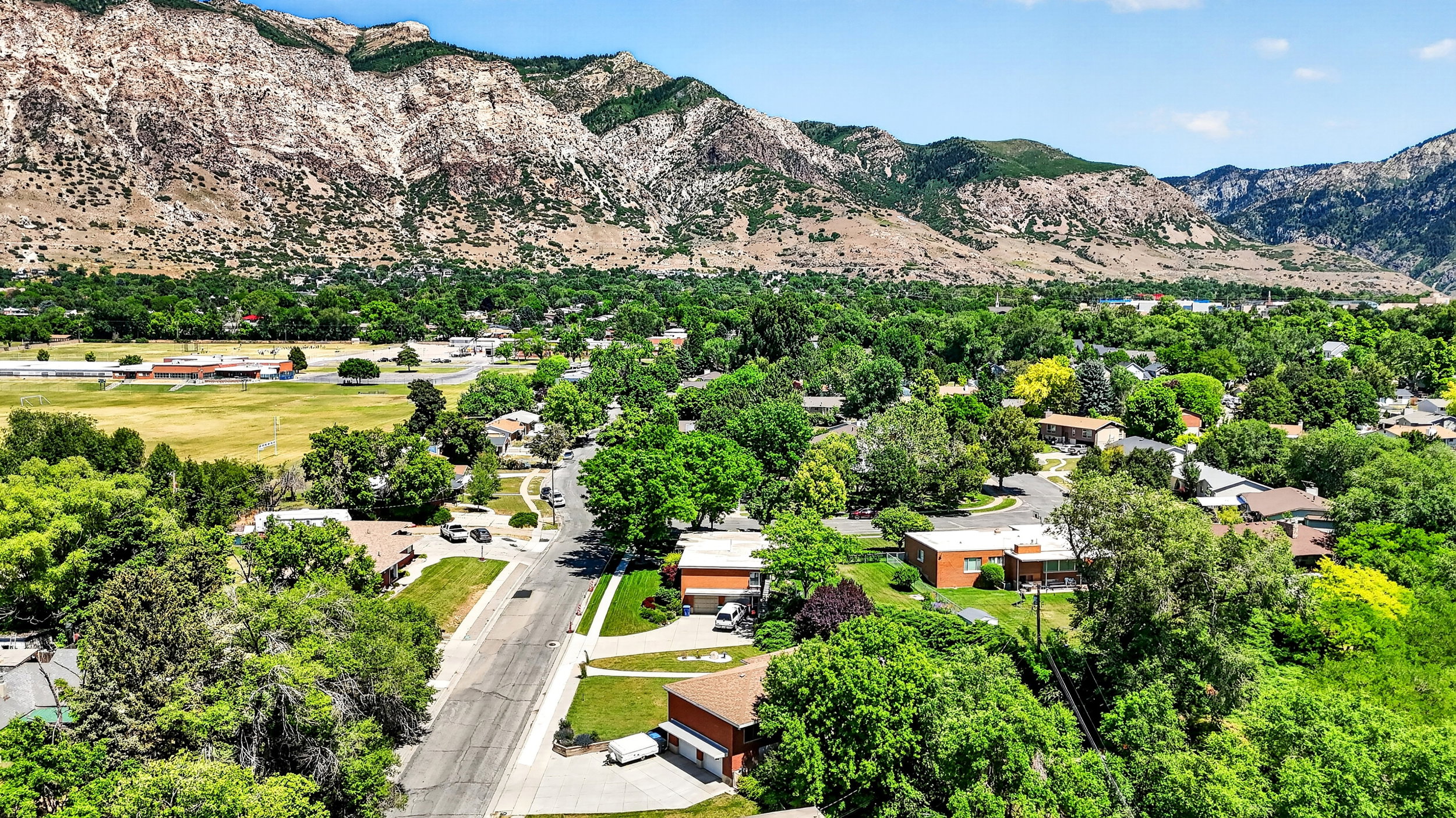 Aerial view showing quiet street and proximity to mountain trails.