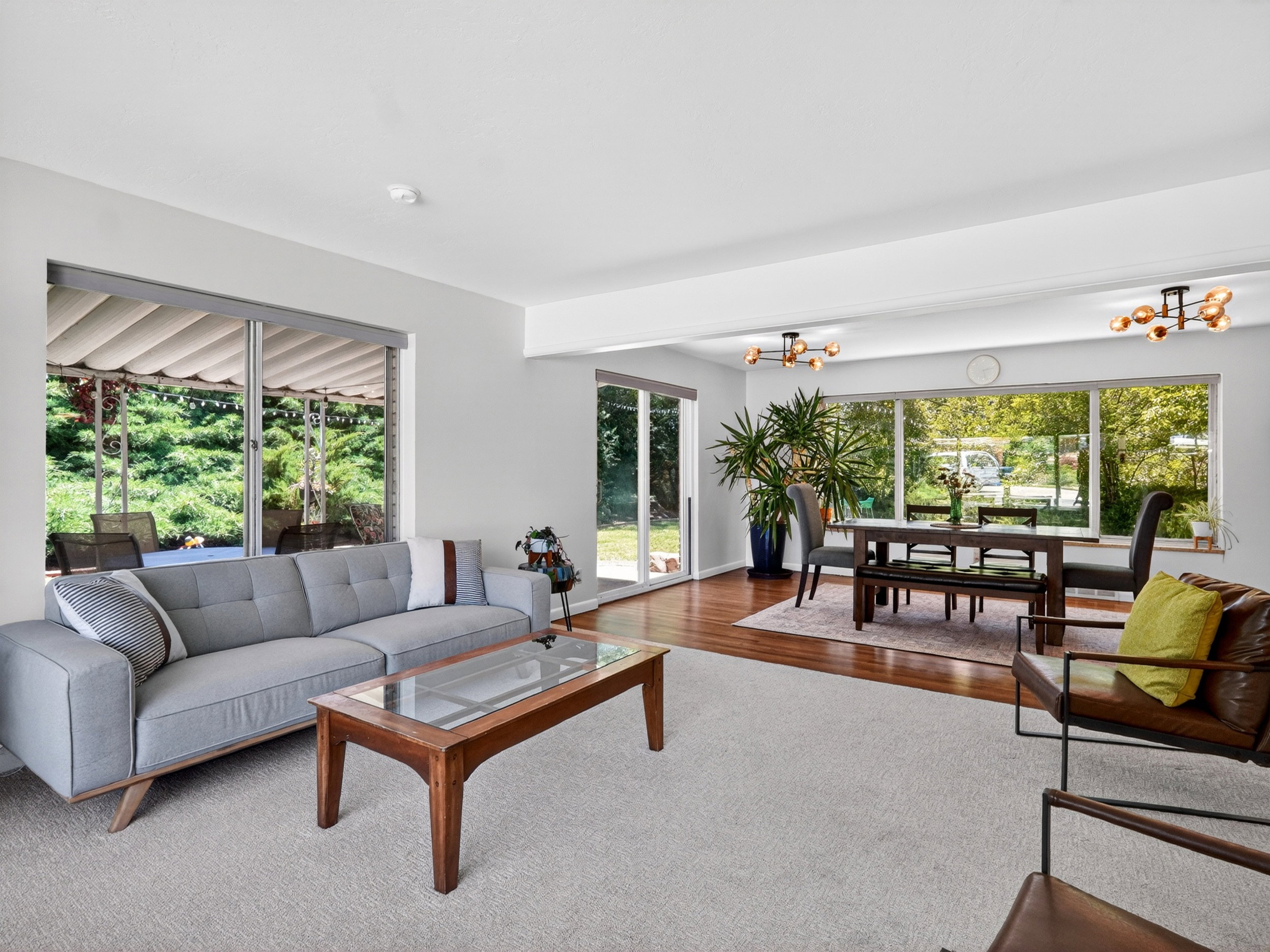 Bright open-concept living space featuring expansive windows and sliding glass doors