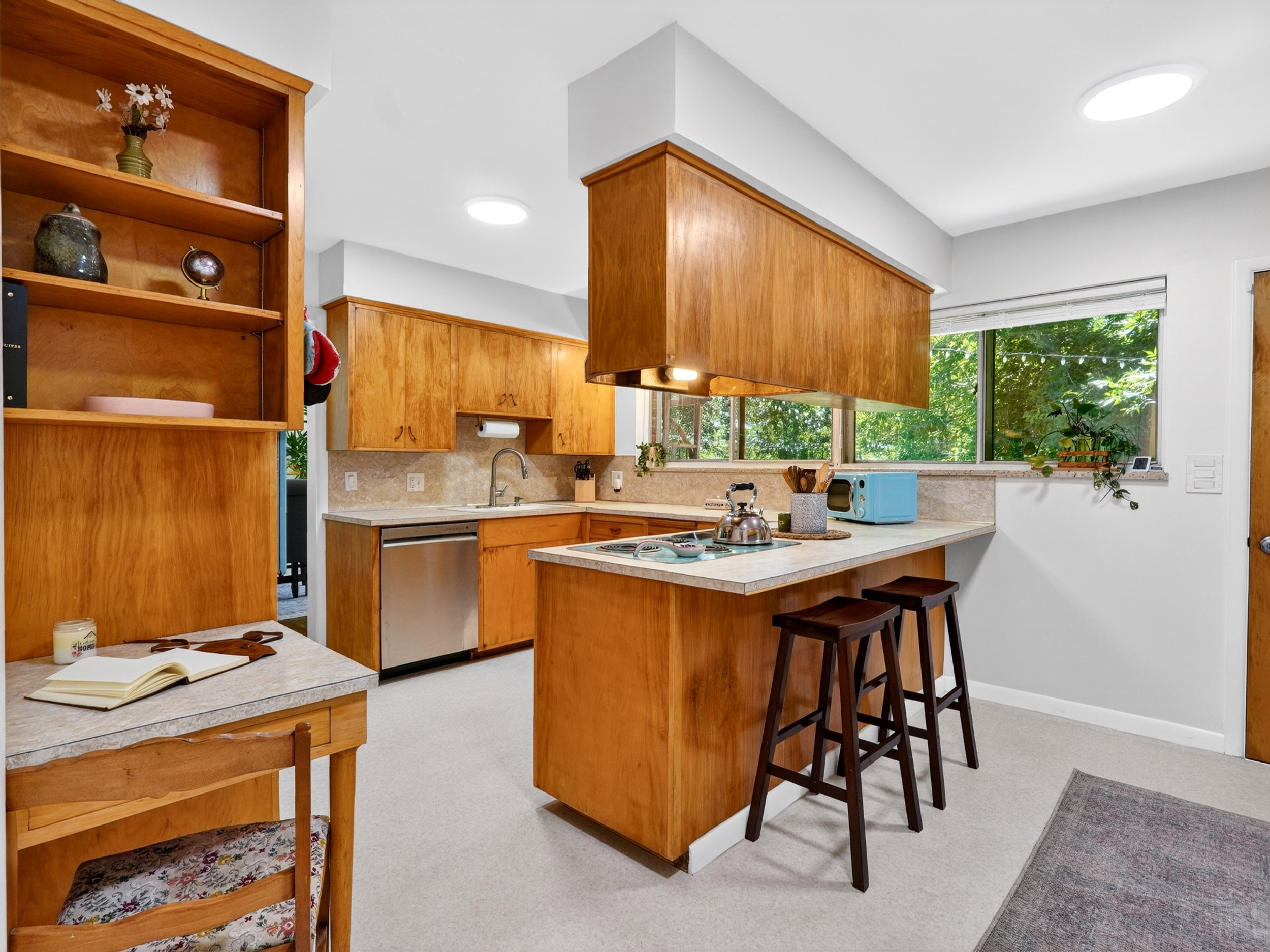 Open kitchen with dishwasher, and breakfast bar.
