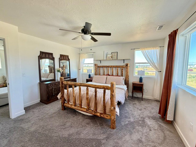 Spacious room featuring neutral carpeting and white walls