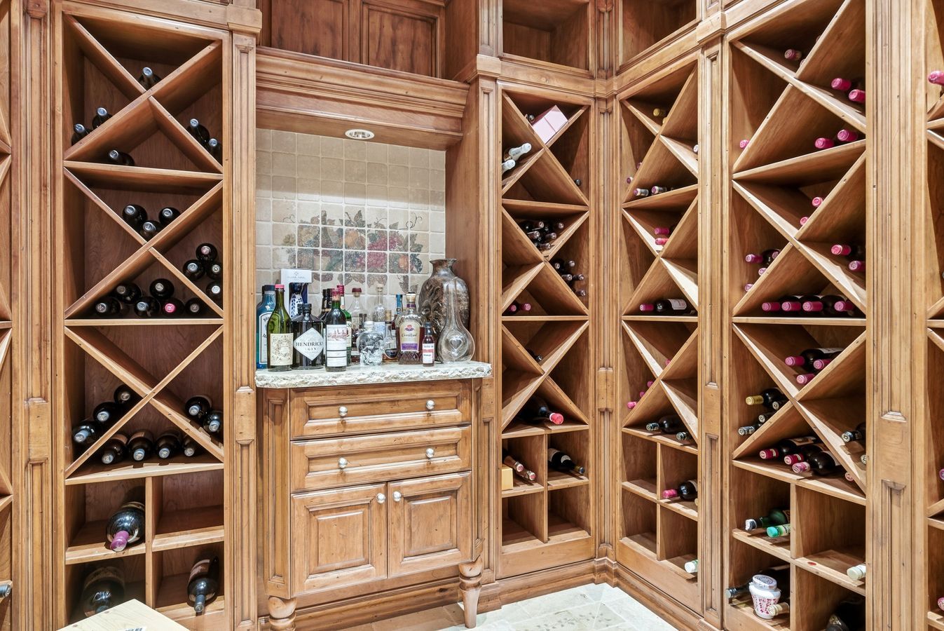 Custom-built wood-finish wine storage cabinetry with X-bins
