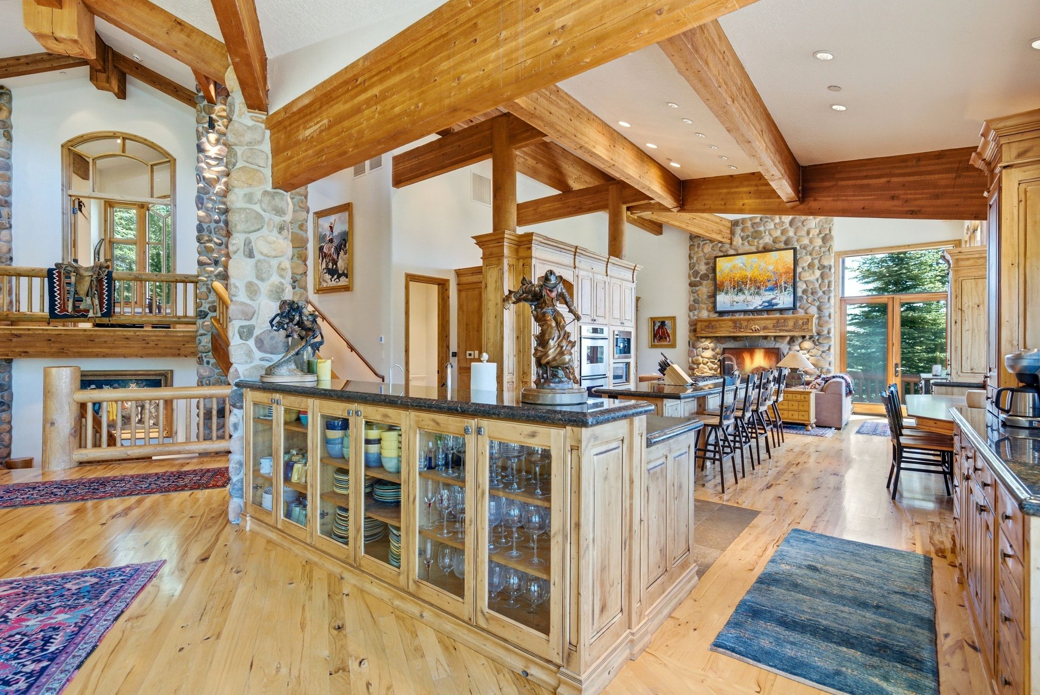Spacious interior featuring exposed wooden beams and light wood-finish flooring