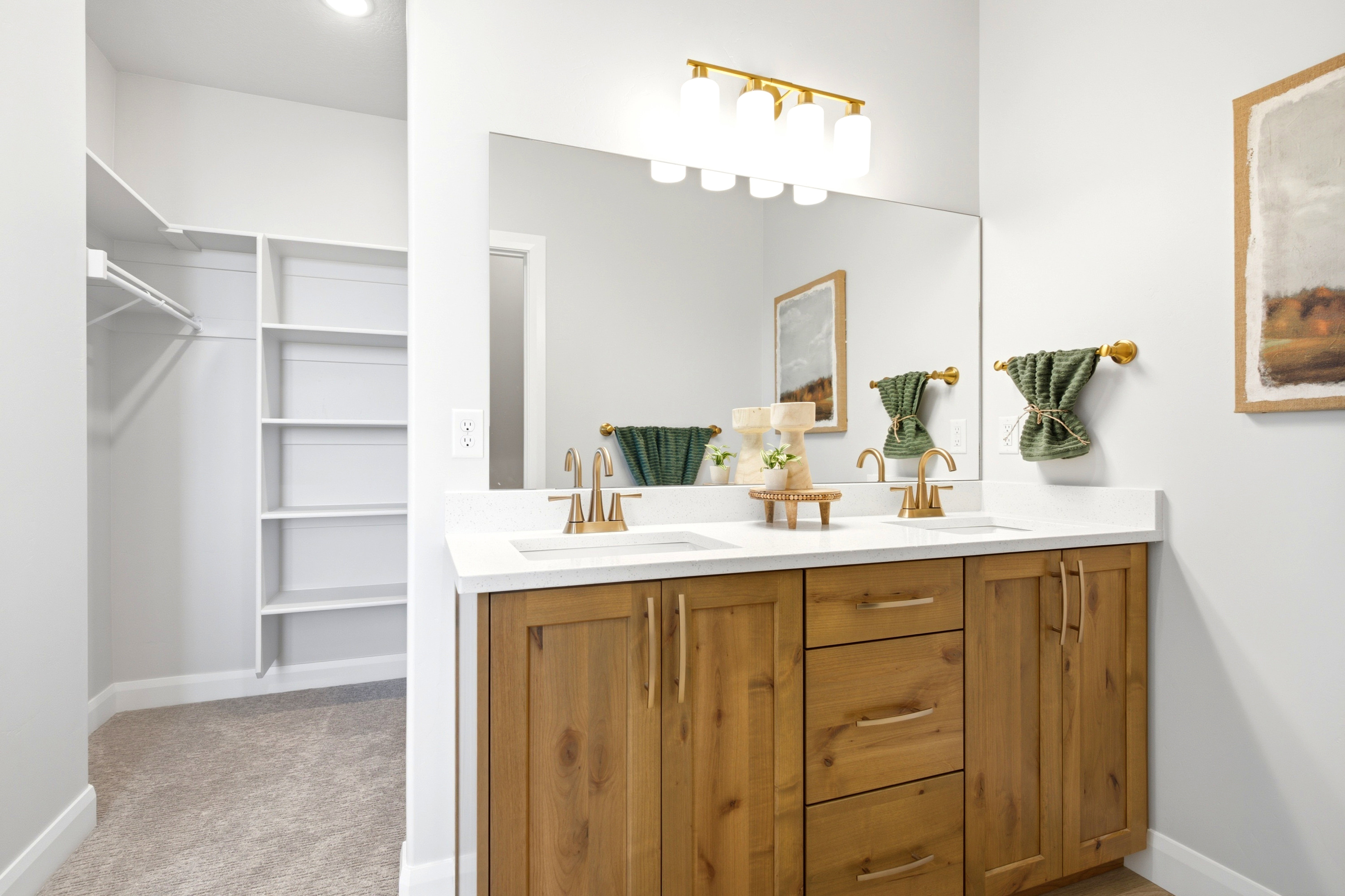 Double vanity with wood-finish cabinetry and white countertops