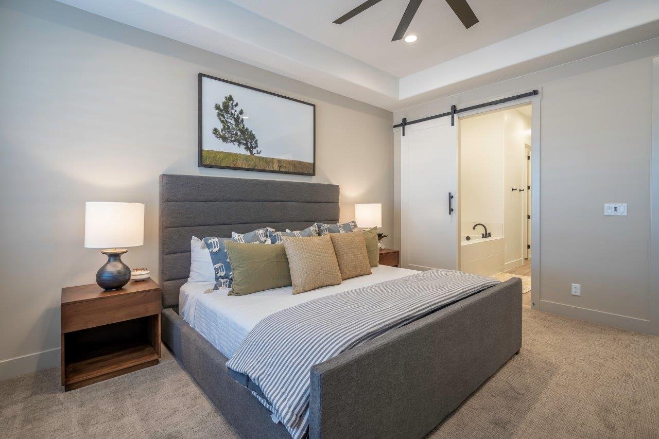 Bedroom featuring a tray ceiling, recessed lighting, and a ceiling fan