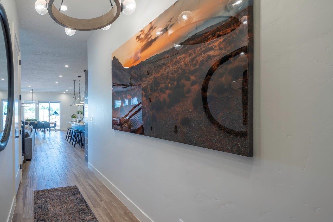 Entryway featuring wood-finish flooring extending into the main living areas, a contemporary chandelier with globe lights, and recessed ceiling lights