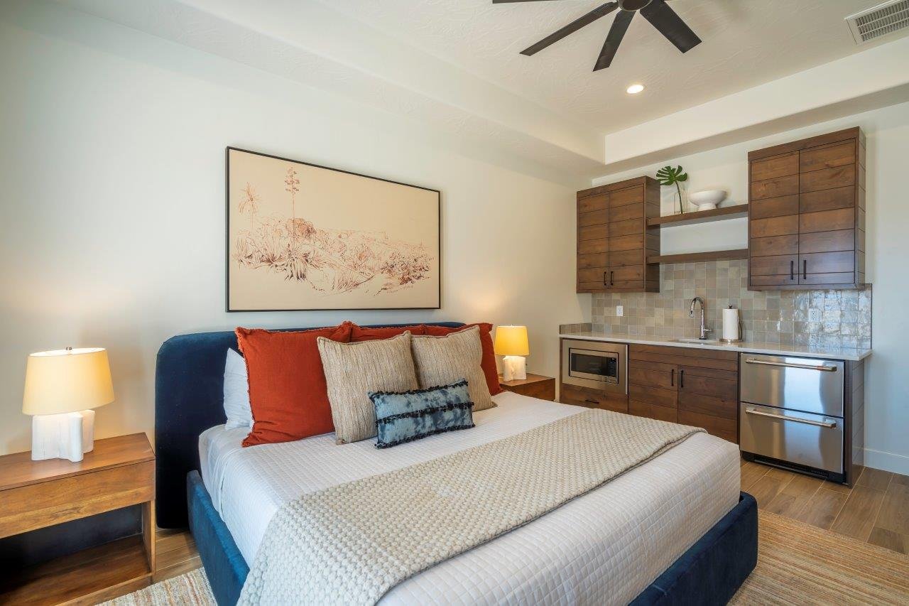 Bedroom featuring wood-finish flooring, a ceiling fan, recessed lighting, and a built-in wet bar