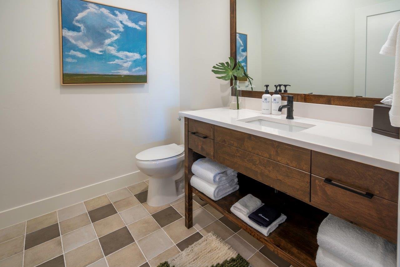 Contemporary vanity with integrated rectangular sink, dark wood-finish cabinetry, and matte black faucet