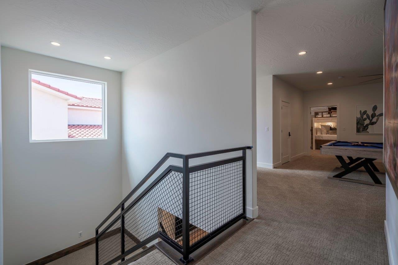 Modern staircase featuring industrial-style metal railings
