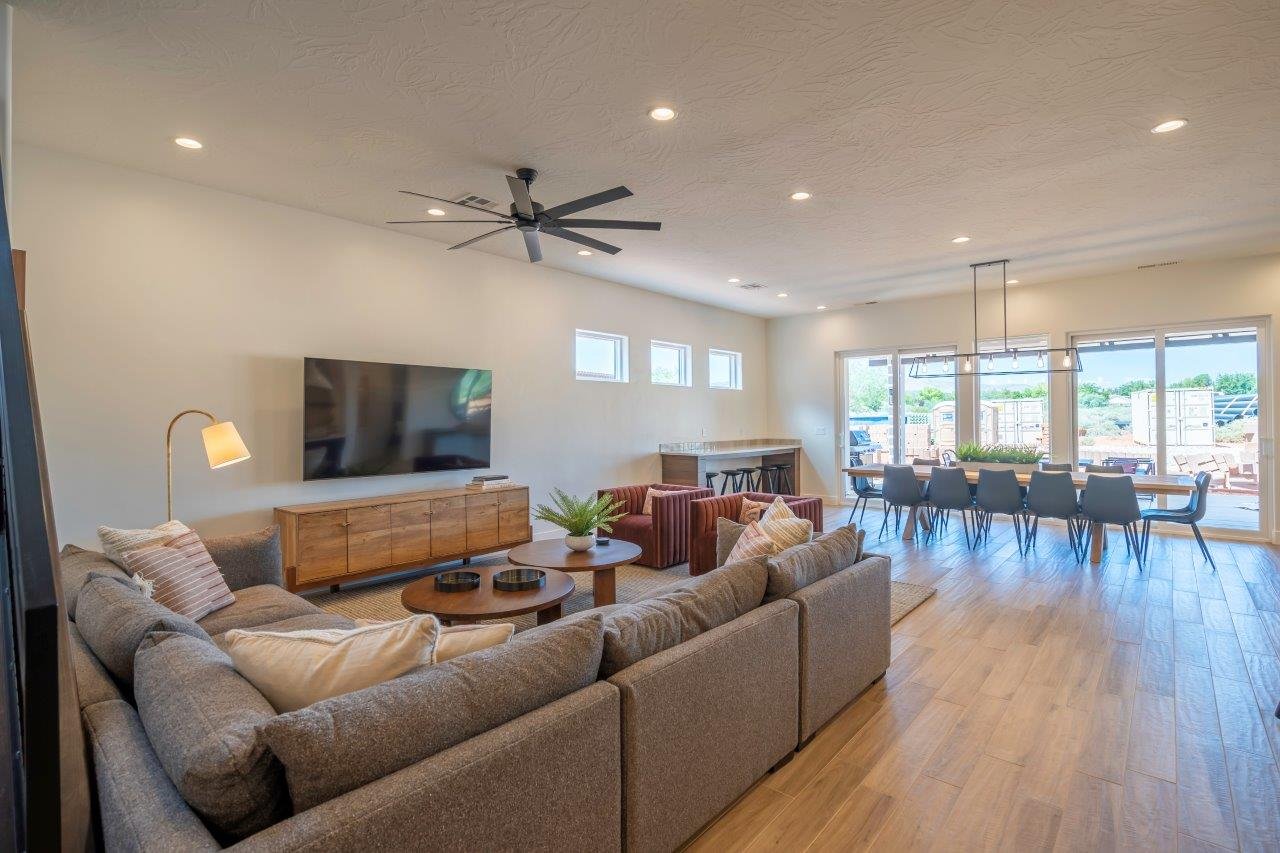 Open concept living and dining area featuring wood-finish flooring, recessed lighting, and a contemporary ceiling fan